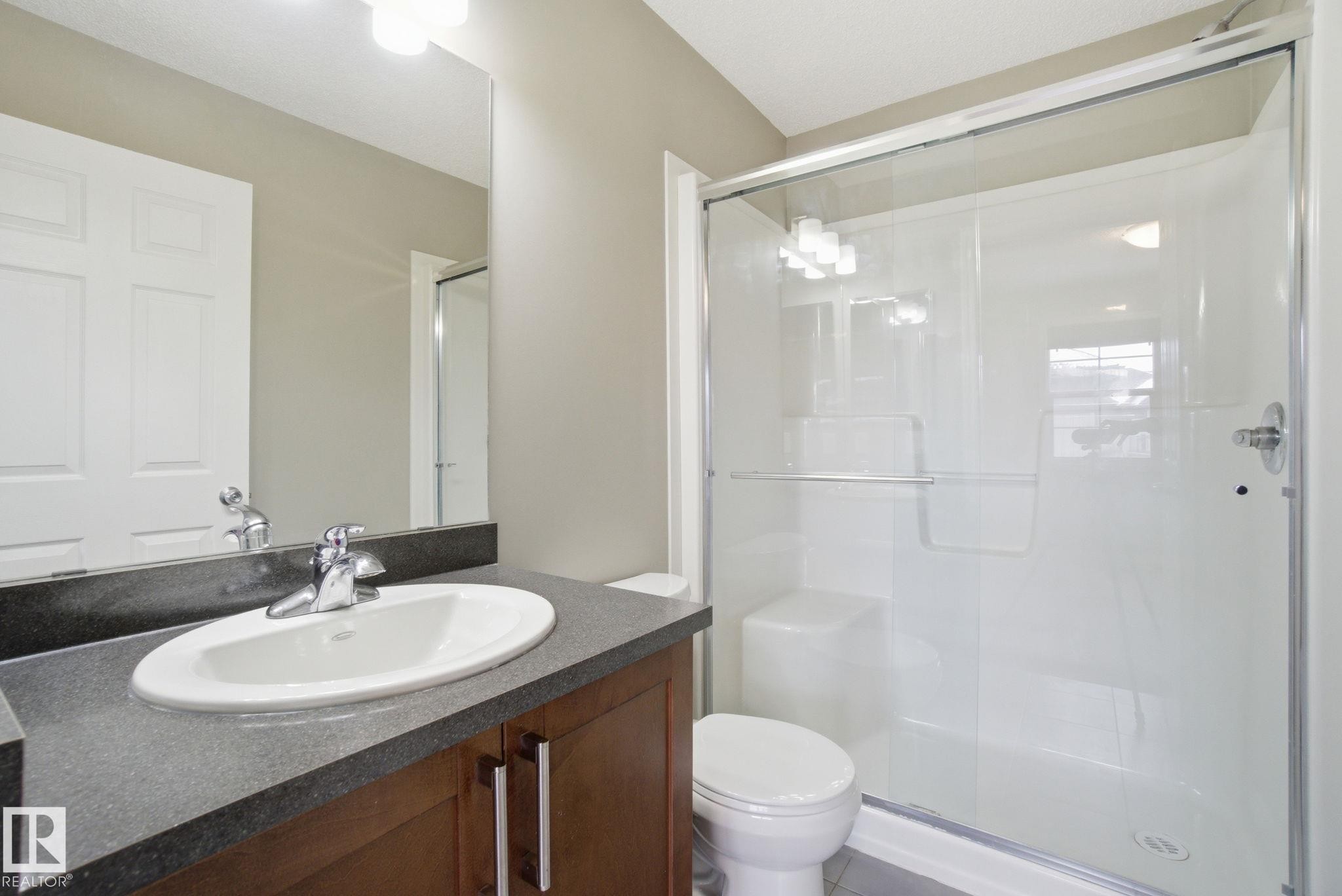 Full bath featuring vanity and a stall shower - 71 4029 Orchards Drive, Edmonton, AB - Indoor Photo Showing Bathroom