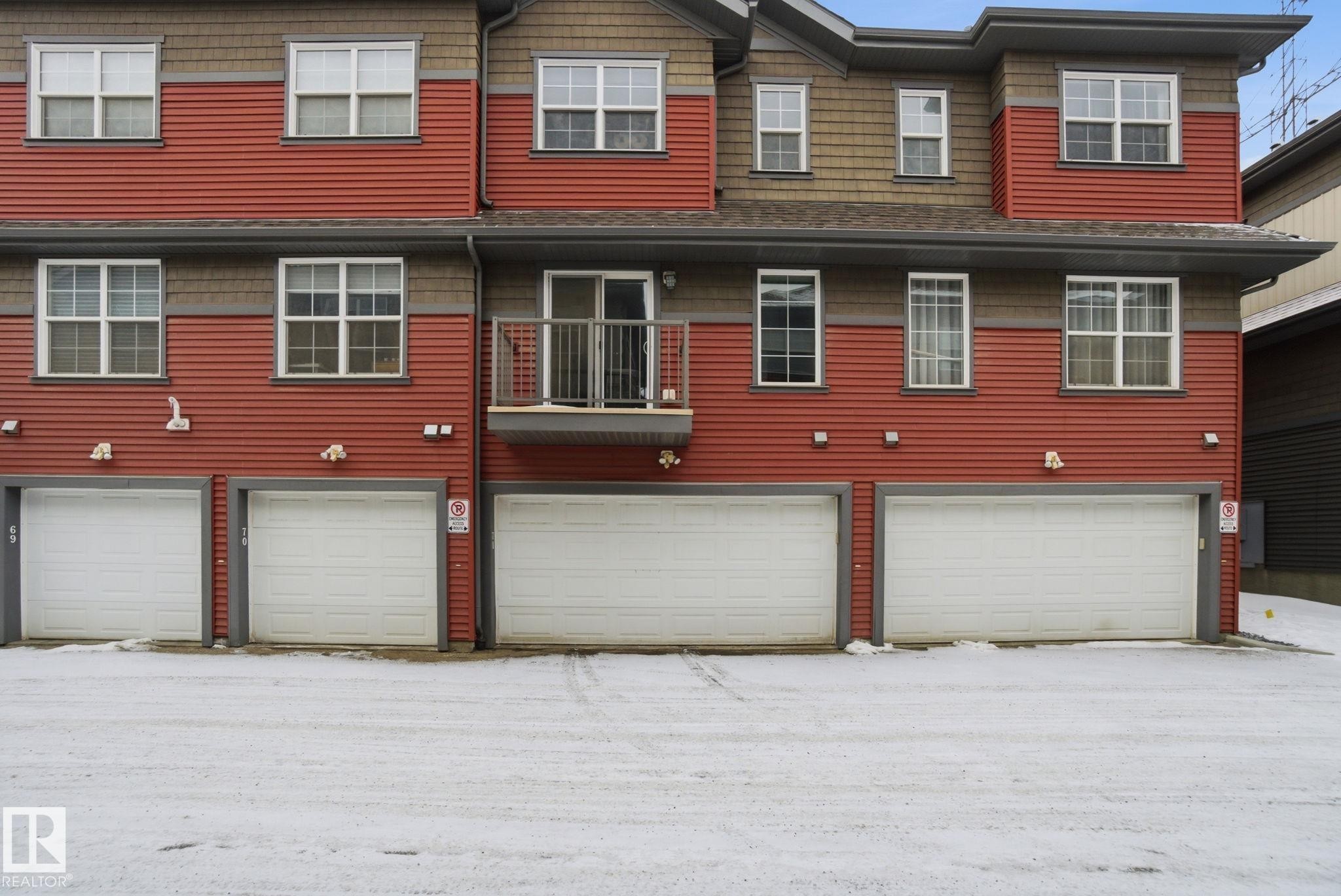 Rear view of property with a garage and a balcony - 71 4029 Orchards Drive, Edmonton, AB - Outdoor With Exterior