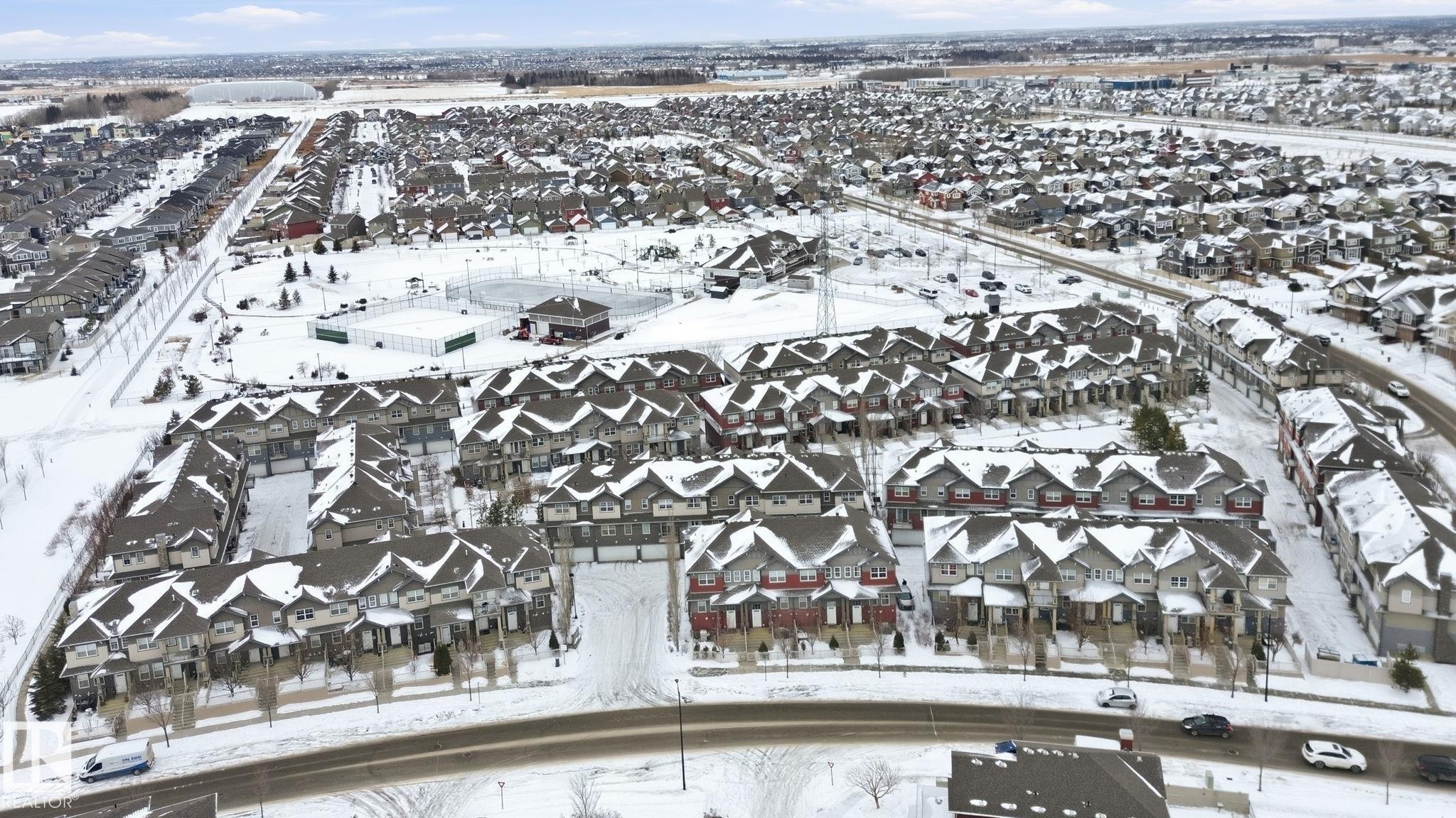 Snowy aerial view featuring a residential view - 71 4029 Orchards Drive, Edmonton, AB - Outdoor With View