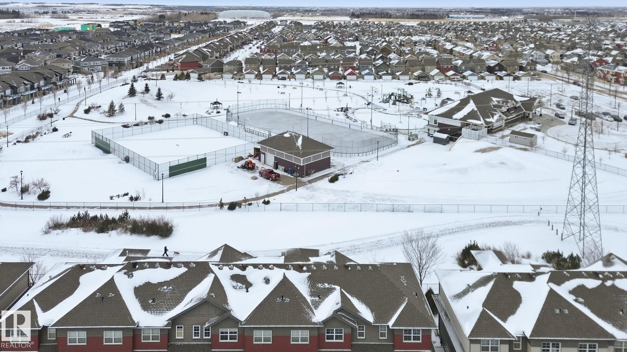 Snowy aerial view with a residential view - 71 4029 Orchards Drive, Edmonton, AB - Outdoor With View