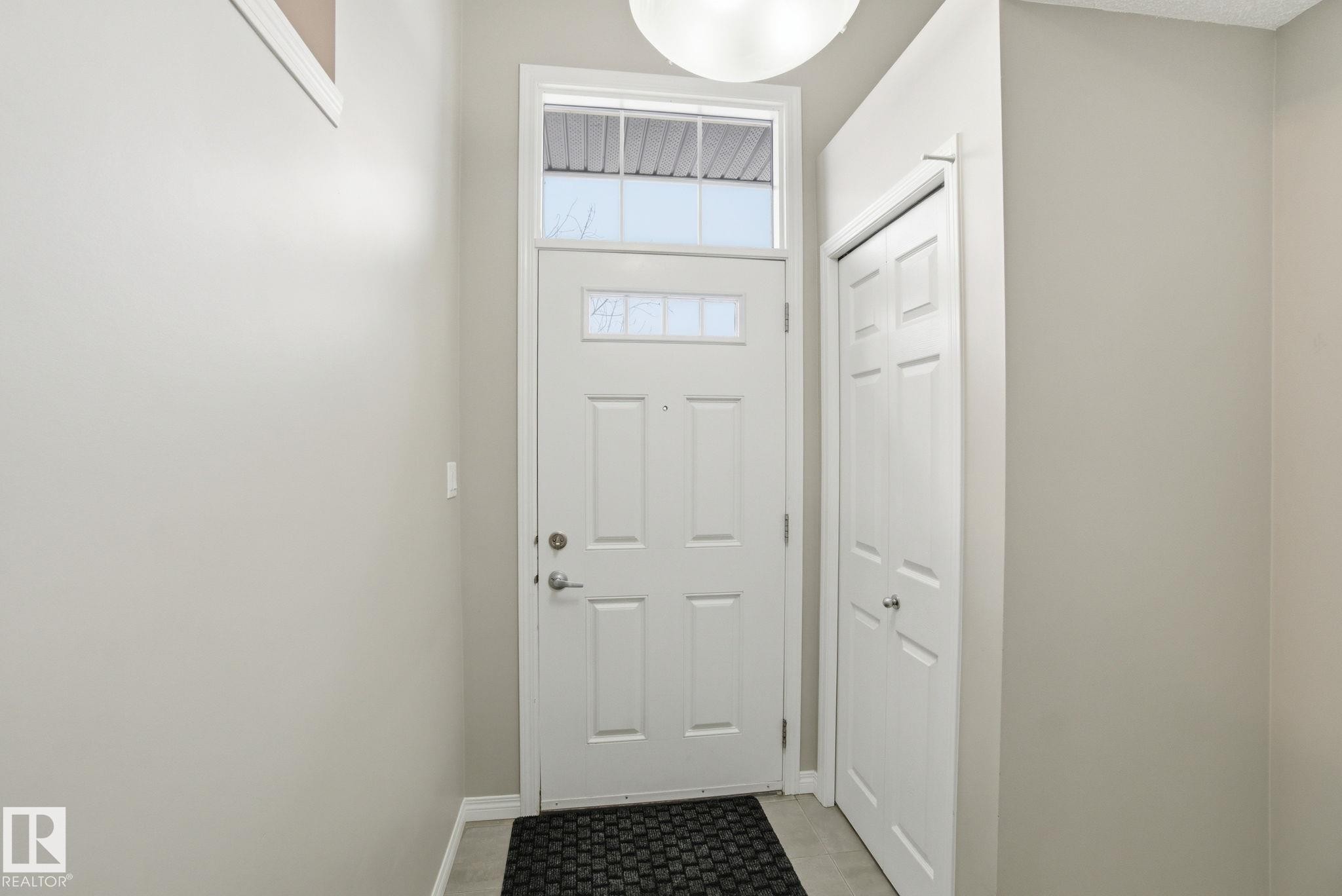 Doorway featuring baseboards - 71 4029 Orchards Drive, Edmonton, AB - Indoor Photo Showing Other Room
