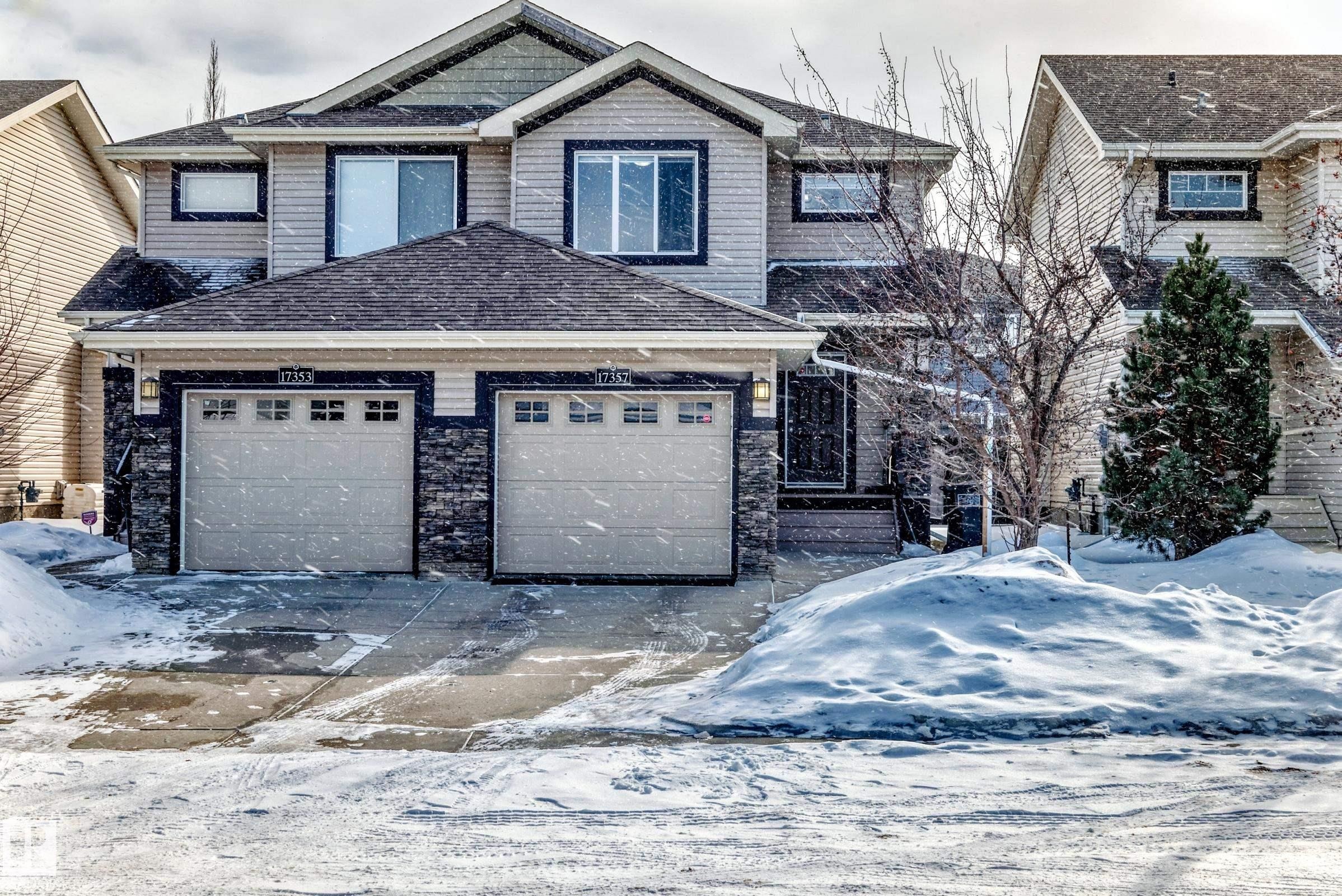 Craftsman-style home with a garage, roof with shingles, and stone siding - 17357 8A Avenue, Edmonton, AB