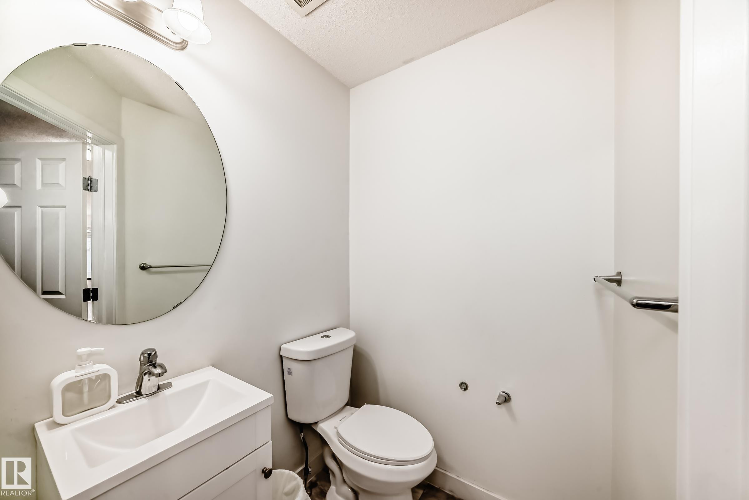 Bathroom with vanity and a textured ceiling - 17357 8A Avenue, Edmonton, AB