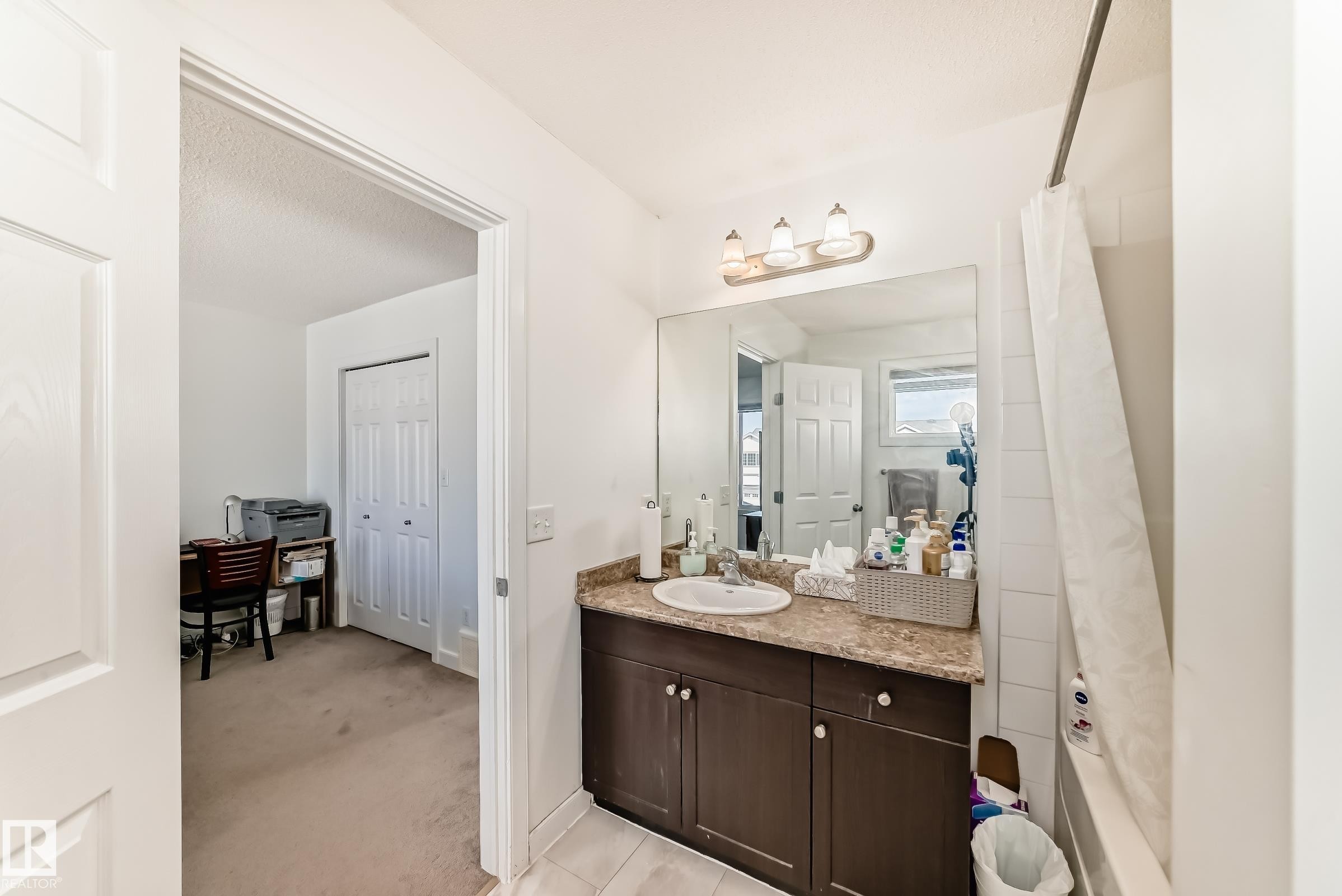 Bathroom featuring vanity, light colored carpet, and a shower with shower curtain - 17357 8A Avenue, Edmonton, AB