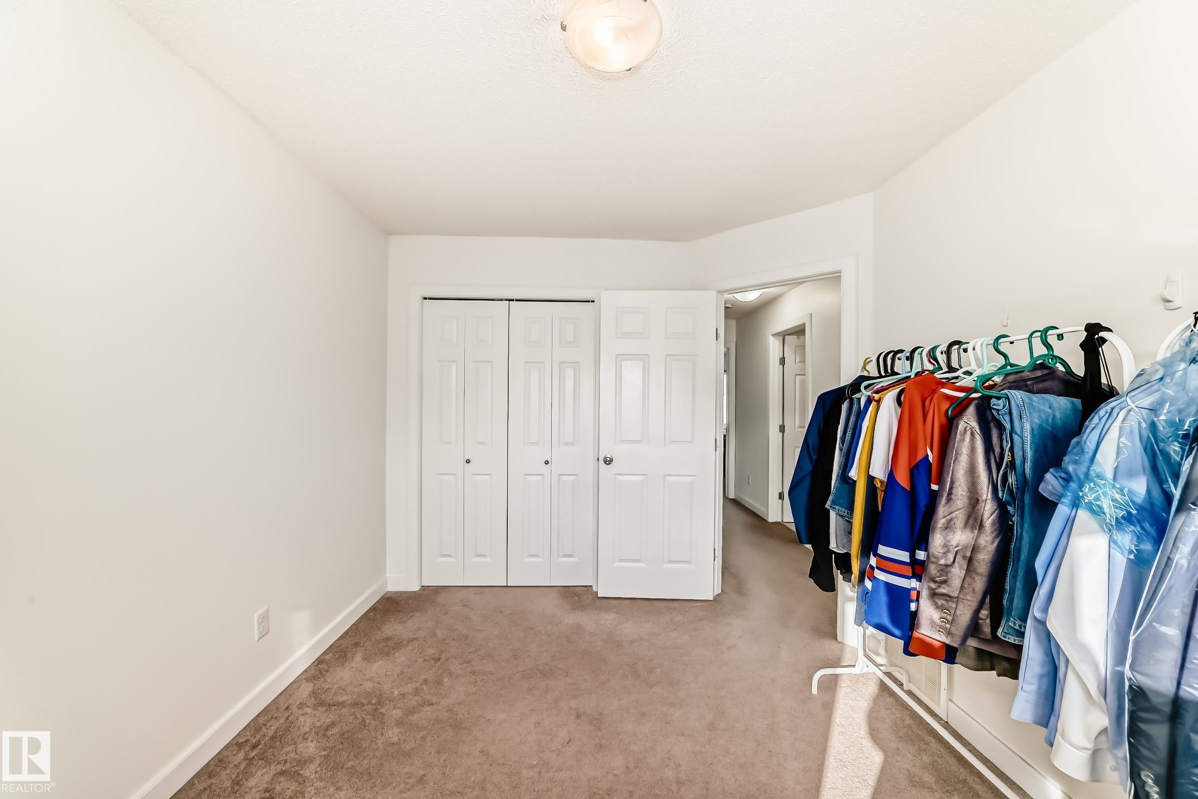 Walk in closet with light colored carpet - 17357 8A Avenue, Edmonton, AB
