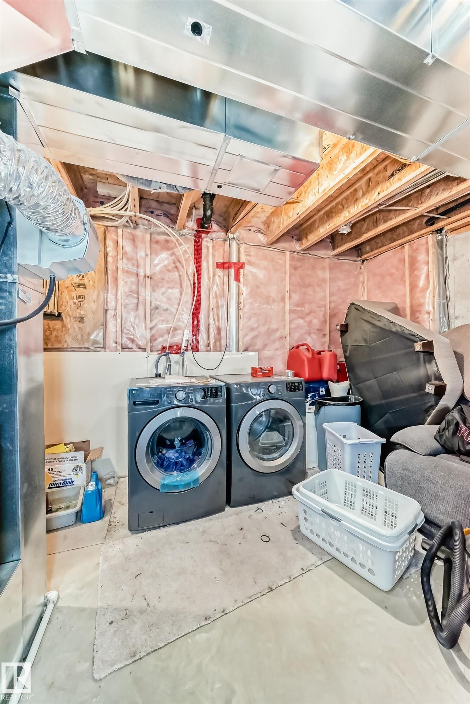 Laundry area featuring concrete flooring and washer and dryer - 17357 8A Avenue, Edmonton, AB