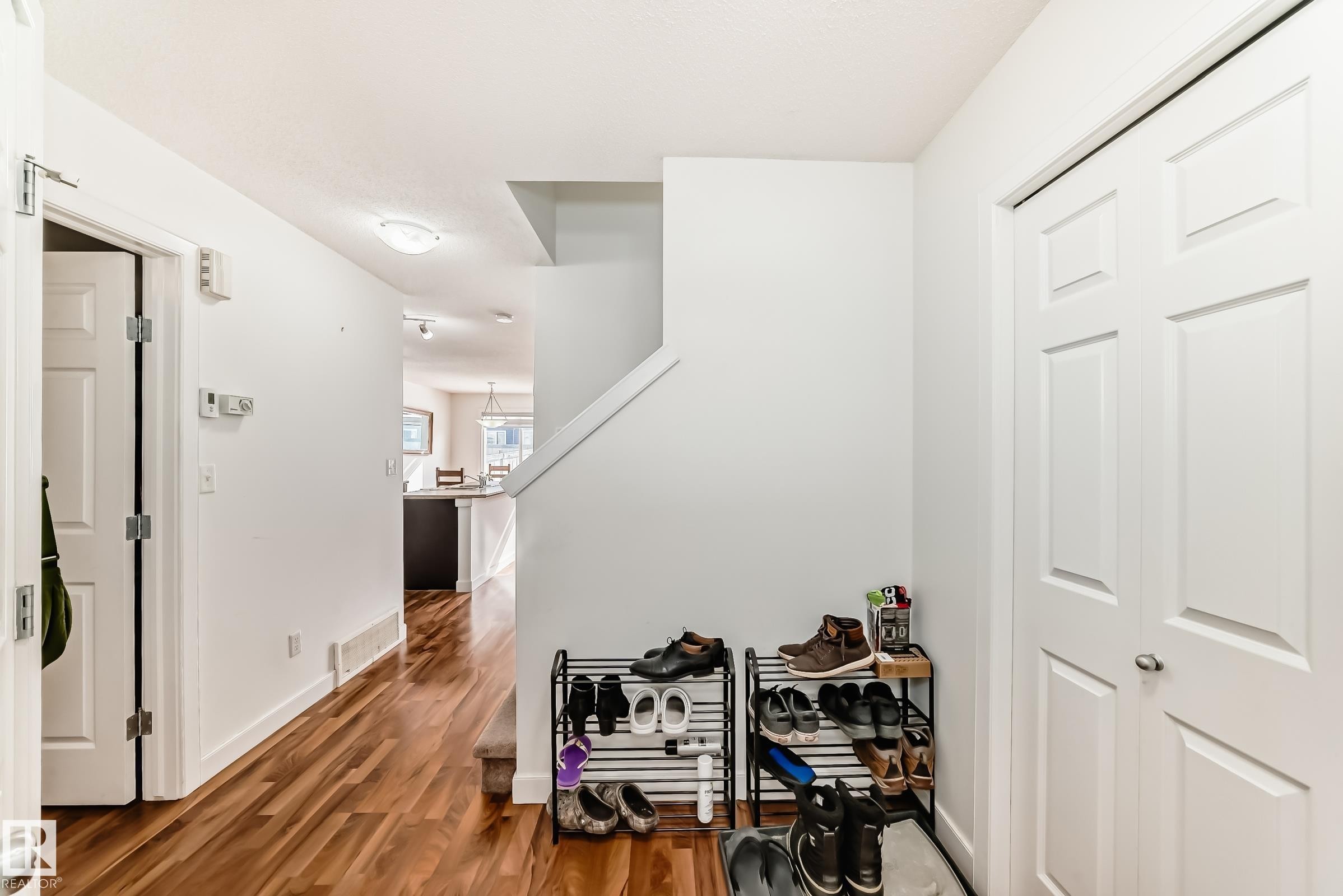 Corridor with dark wood-style flooring and baseboards - 17357 8A Avenue, Edmonton, AB