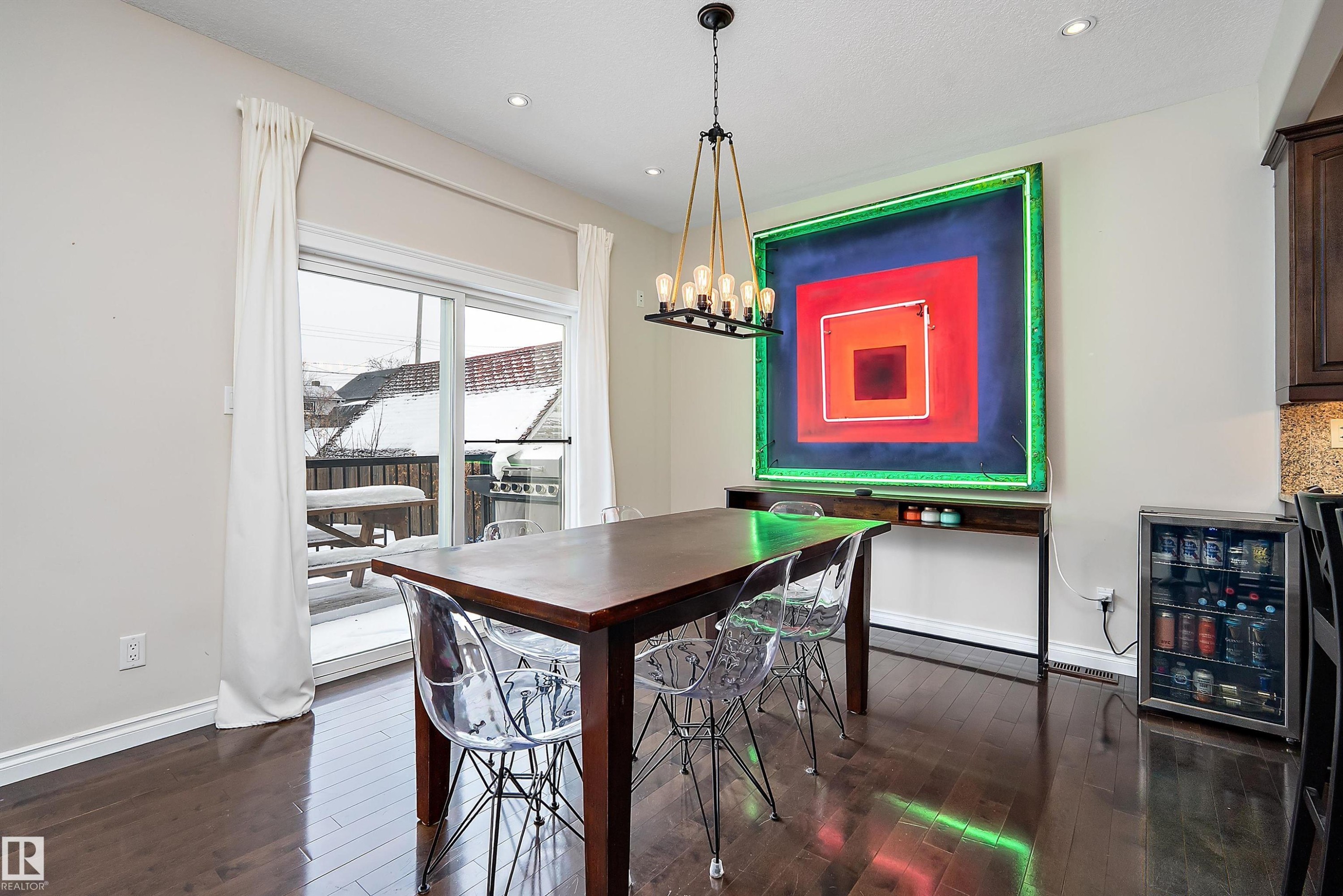 Dining space with beverage cooler, dark wood-style flooring, and hanging lights - 10623 75 Avenue, Edmonton, AB - Indoor Photo Showing Dining Room