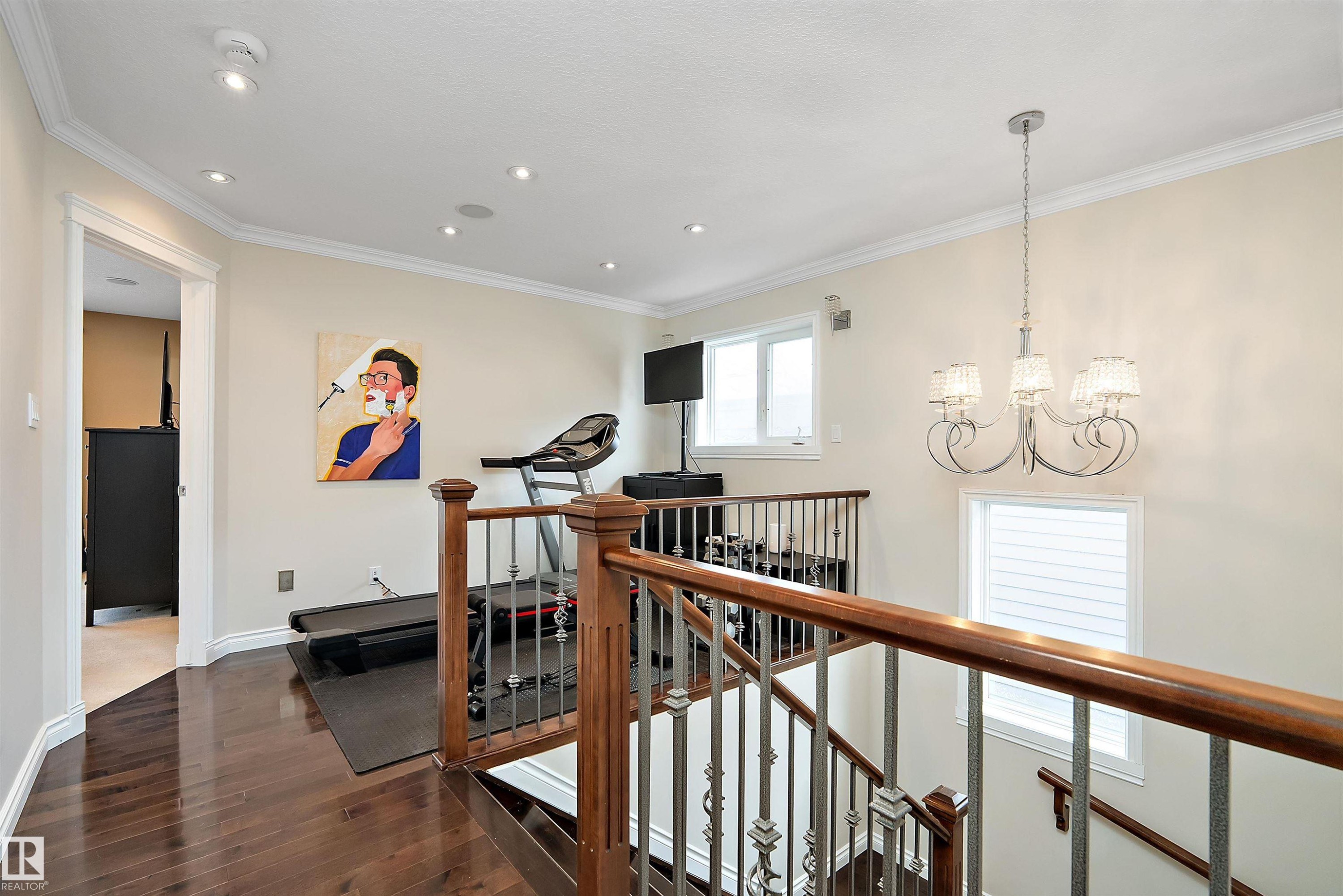 Corridor featuring an upstairs landing, a chandelier, dark wood-style flooring, and crown molding - 10623 75 Avenue, Edmonton, AB - Indoor Photo Showing Other Room