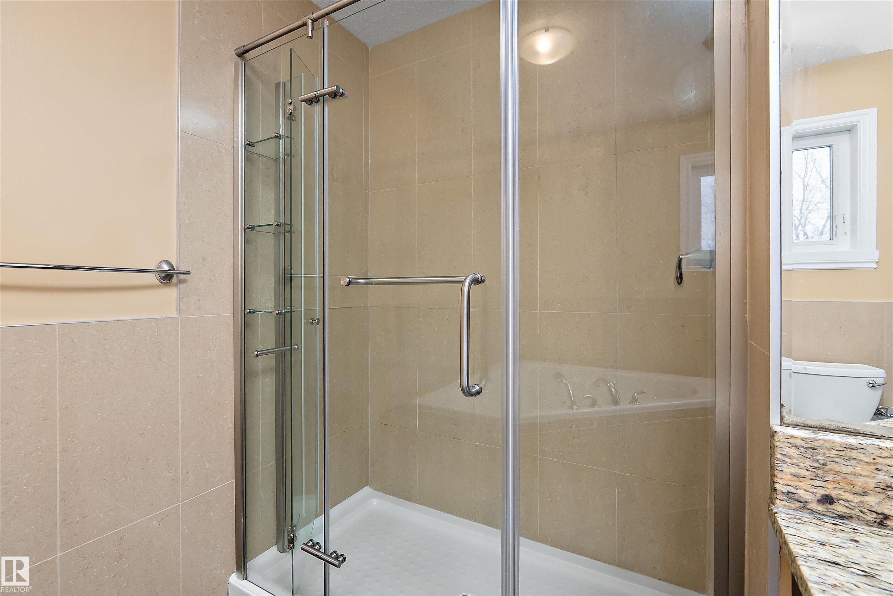 Full bath with tile walls, a garden tub, a stall shower, vanity, and a wainscoted wall - 10623 75 Avenue, Edmonton, AB - Indoor Photo Showing Bathroom
