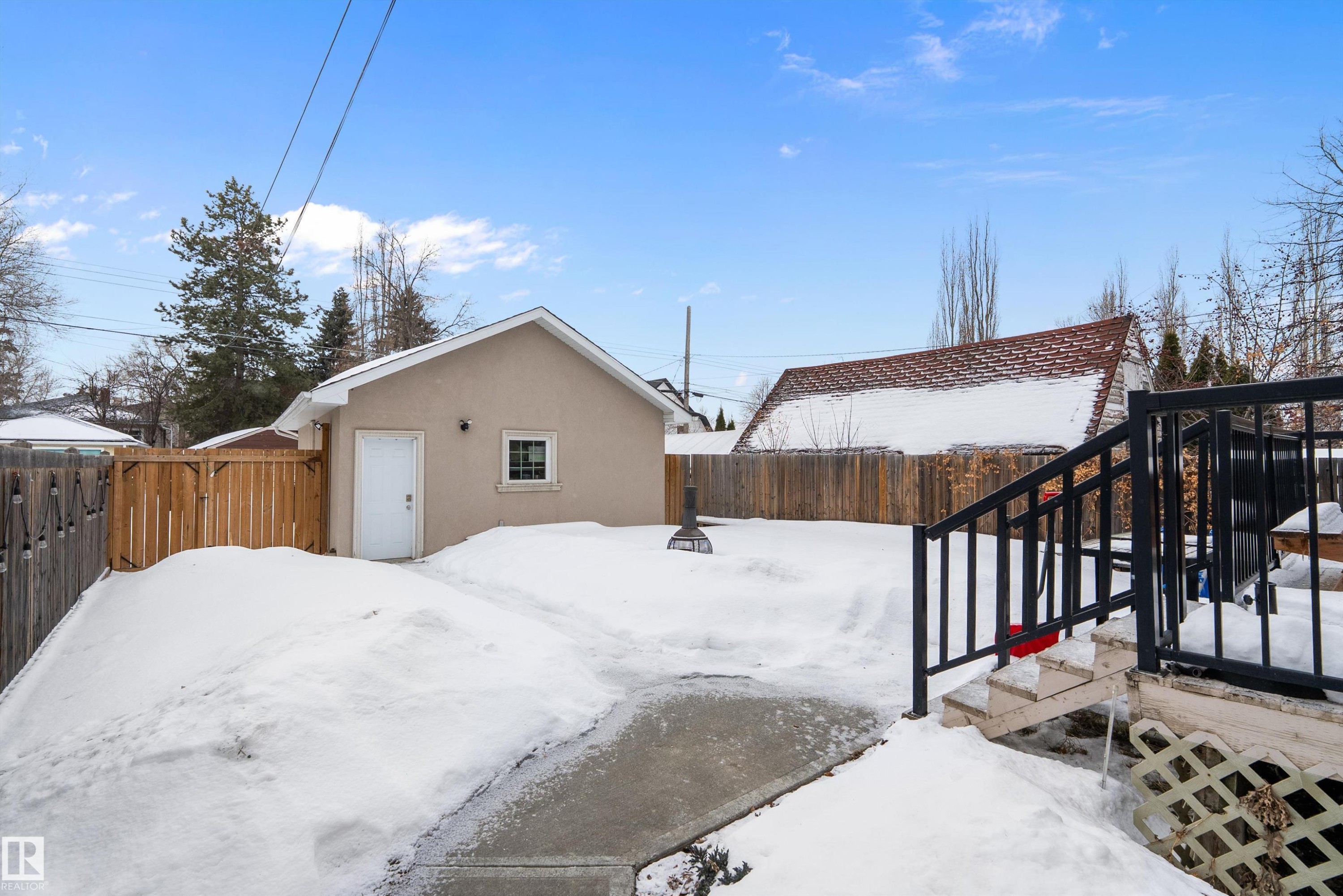 Yard covered in snow with a fenced backyard - 10623 75 Avenue, Edmonton, AB - Outdoor With Exterior