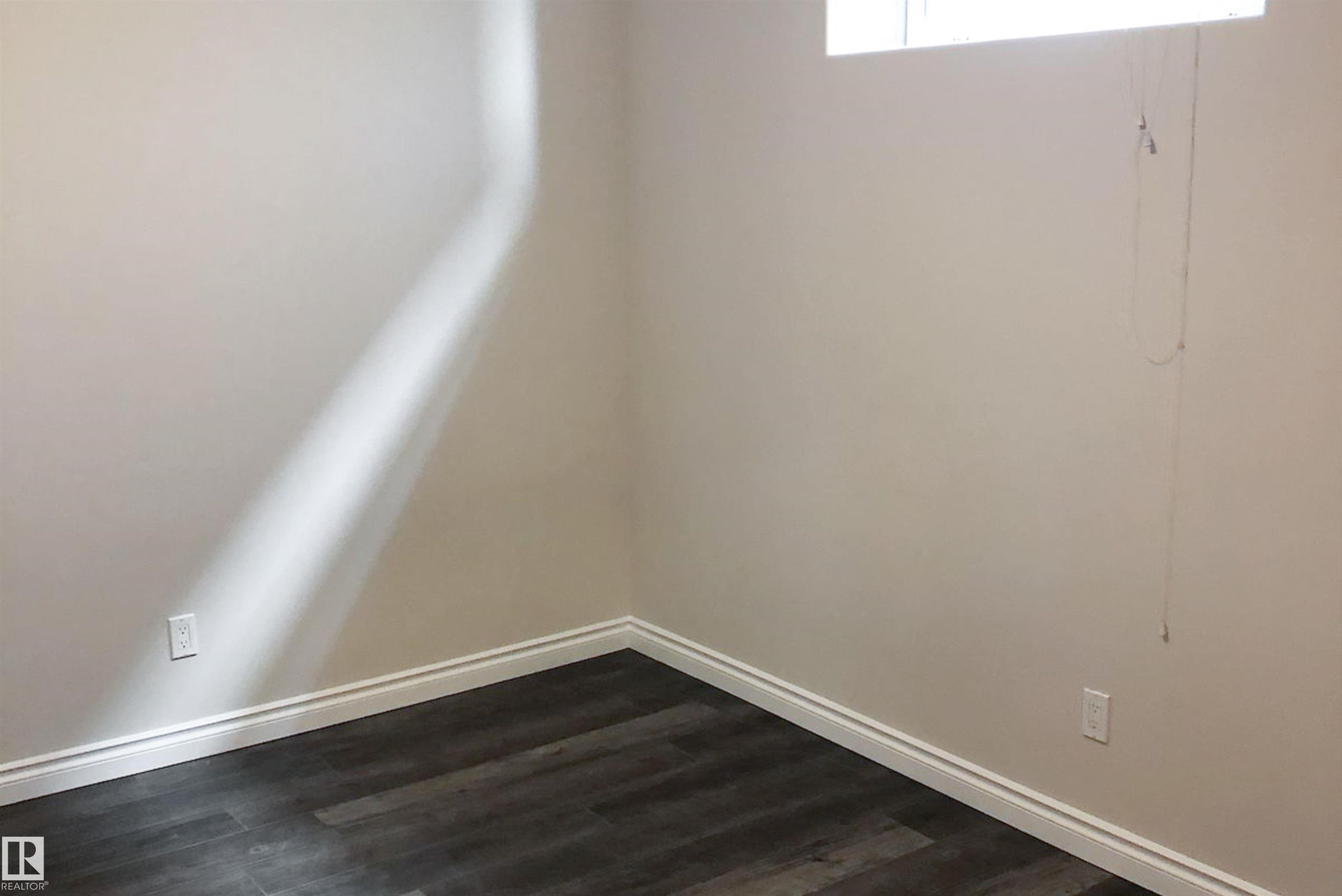 Empty room with dark wood-type flooring - 10623 75 Avenue, Edmonton, AB - Indoor Photo Showing Other Room
