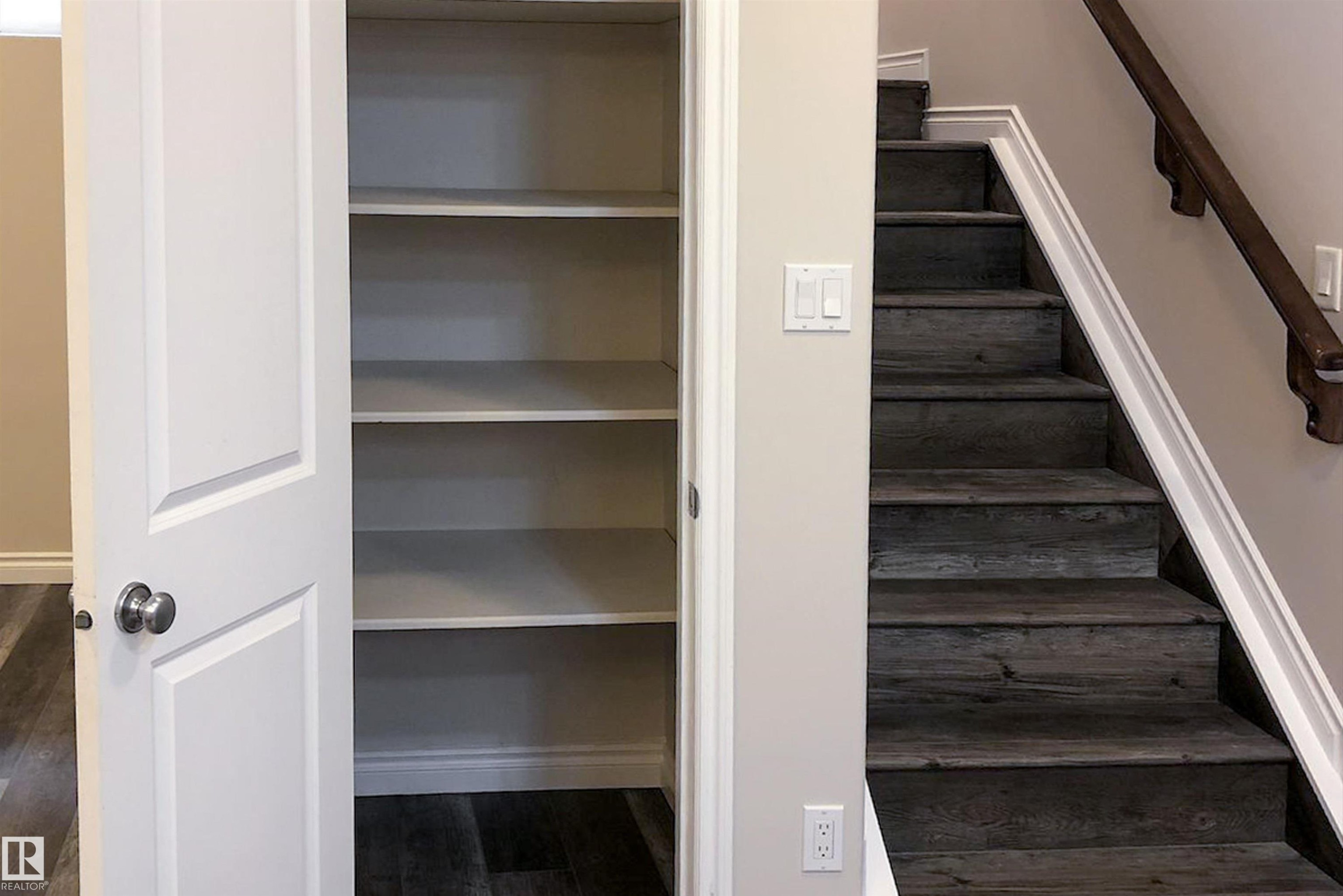 Stairway featuring wood finished floors and baseboards - 10623 75 Avenue, Edmonton, AB - Indoor Photo Showing Other Room