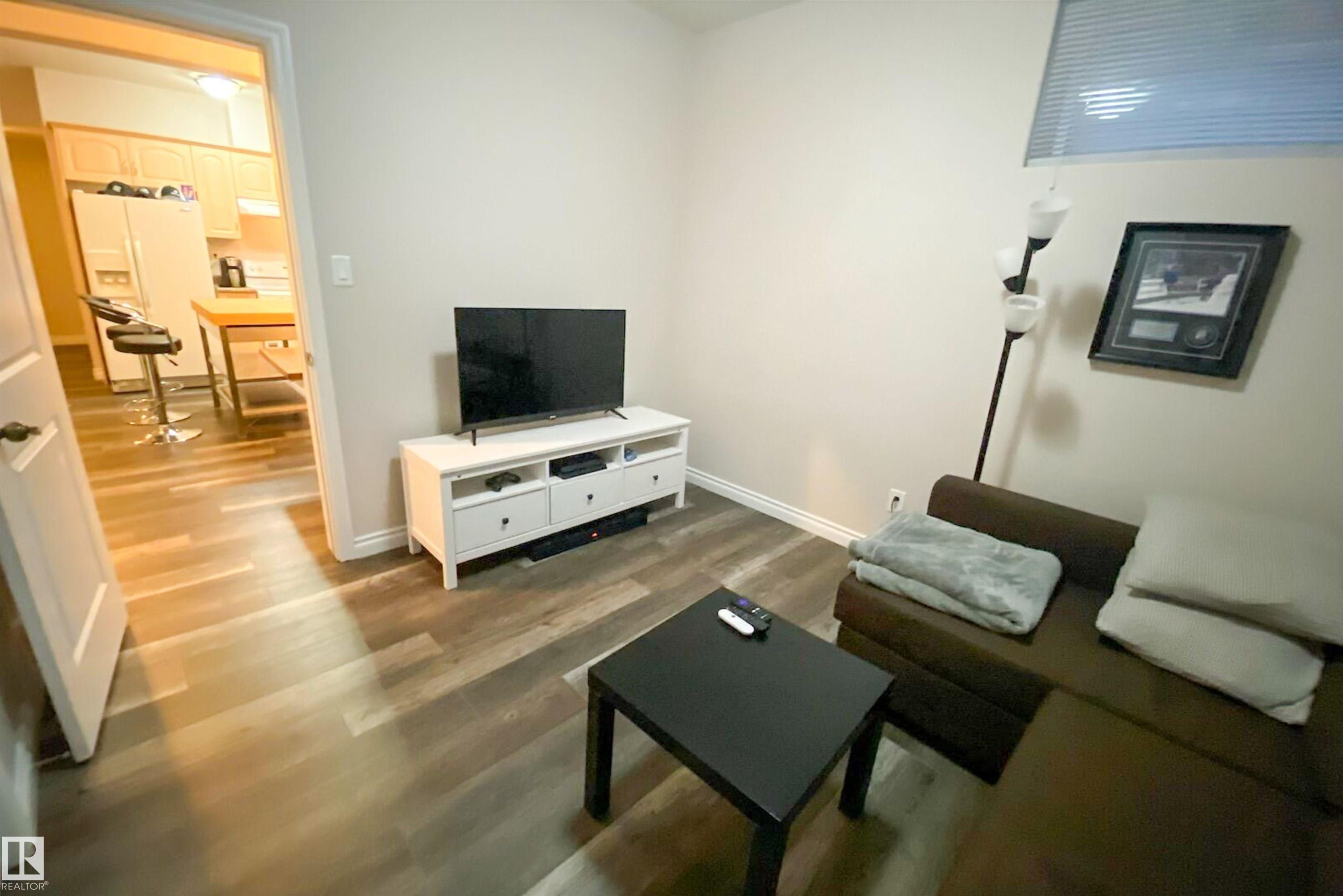 Living area with wood finished floors and baseboards - 10623 75 Avenue, Edmonton, AB - Indoor Photo Showing Living Room