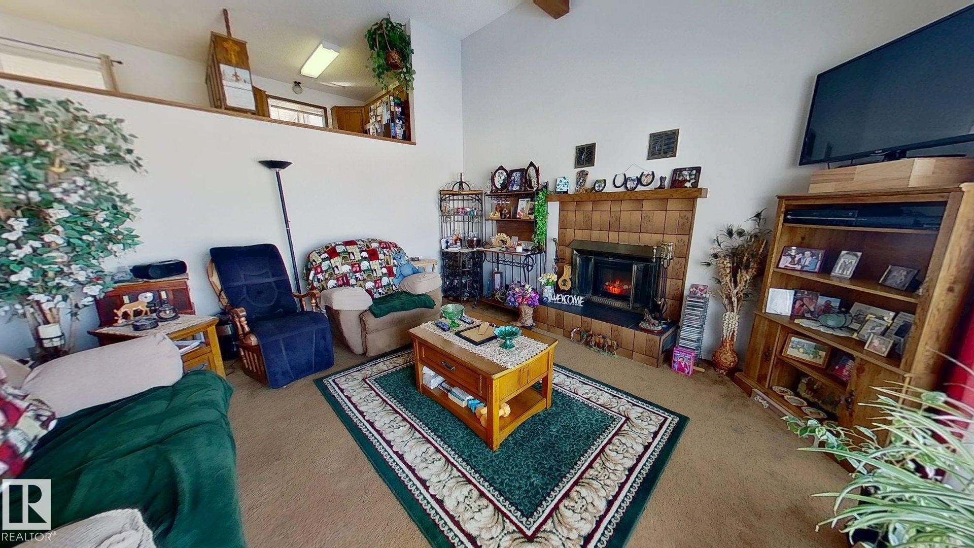 5307 Willow Drive, Boyle, AB - Indoor Photo Showing Other Room With Fireplace