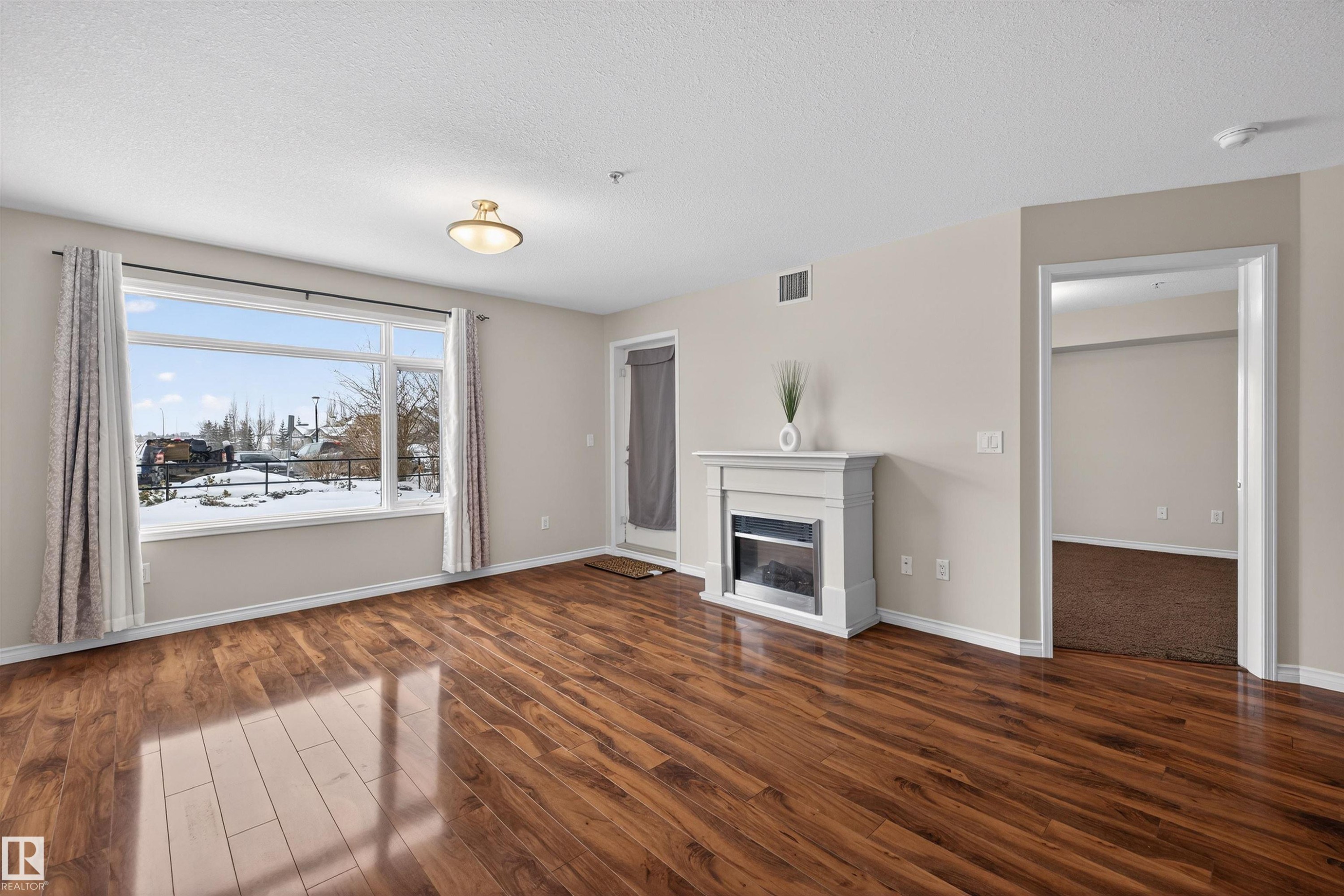 102 1589 Glastonbury Boulevard, Edmonton, AB - Indoor Photo Showing Living Room With Fireplace