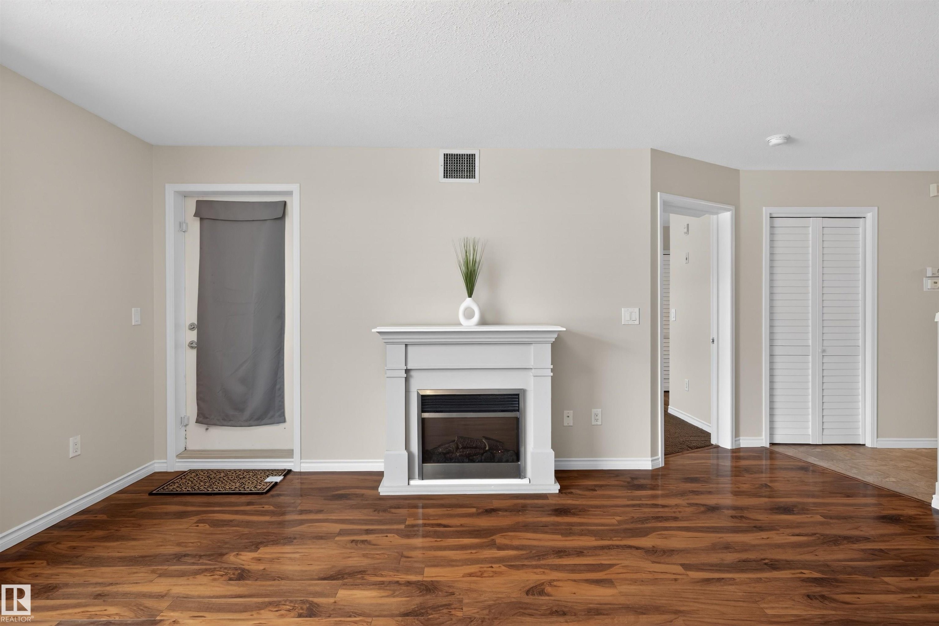102 1589 Glastonbury Boulevard, Edmonton, AB - Indoor Photo Showing Other Room With Fireplace
