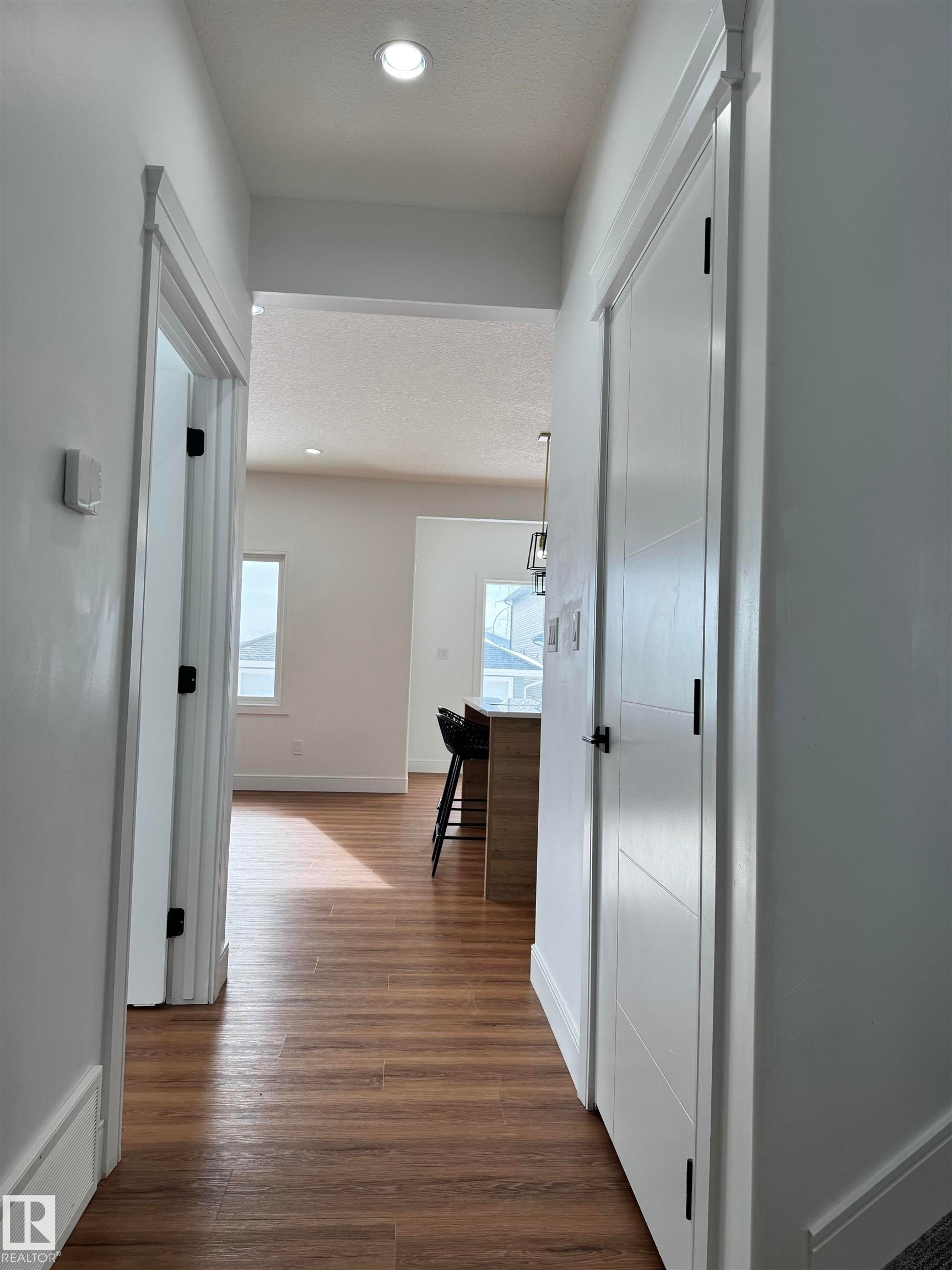 Corridor with recessed lighting, dark wood finished floors, and a textured ceiling - 1703 152 Avenue, Edmonton, AB - Indoor Photo Showing Other Room