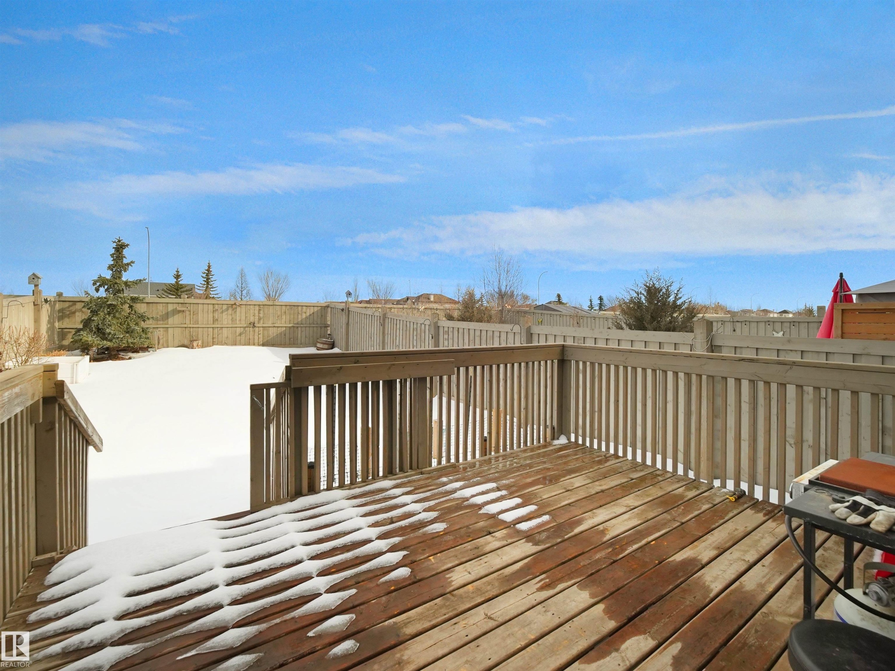 Wooden terrace featuring a fenced backyard and a residential view - 8921 217 St Nw, Edmonton, AB - Outdoor With Deck Patio Veranda