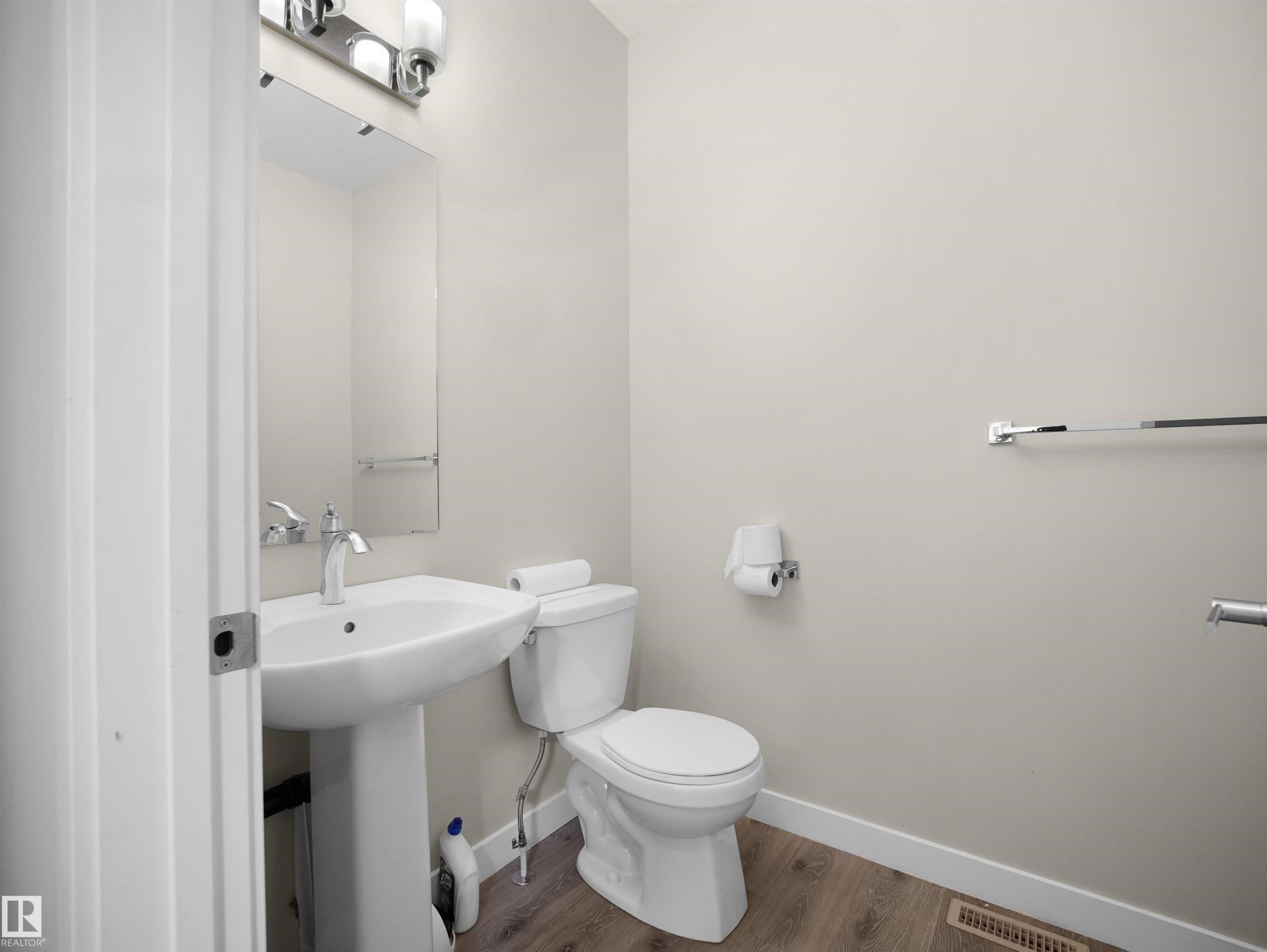 Bathroom with toilet and wood finished floors - 8921 217 St Nw, Edmonton, AB - Indoor Photo Showing Bathroom