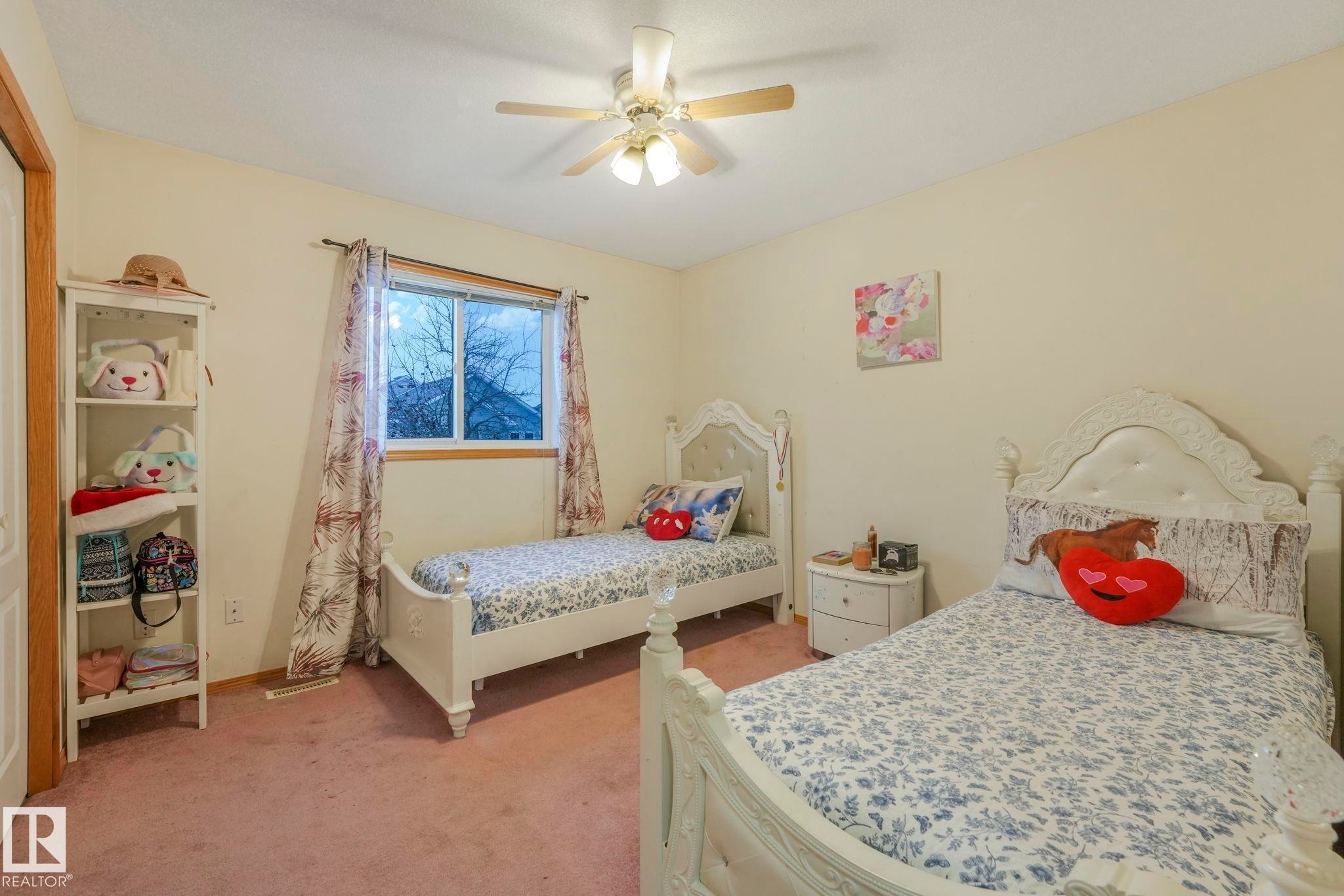 Bedroom with light carpet and ceiling fan - 4720 150 Avenue, Edmonton, AB - Indoor Photo Showing Bedroom