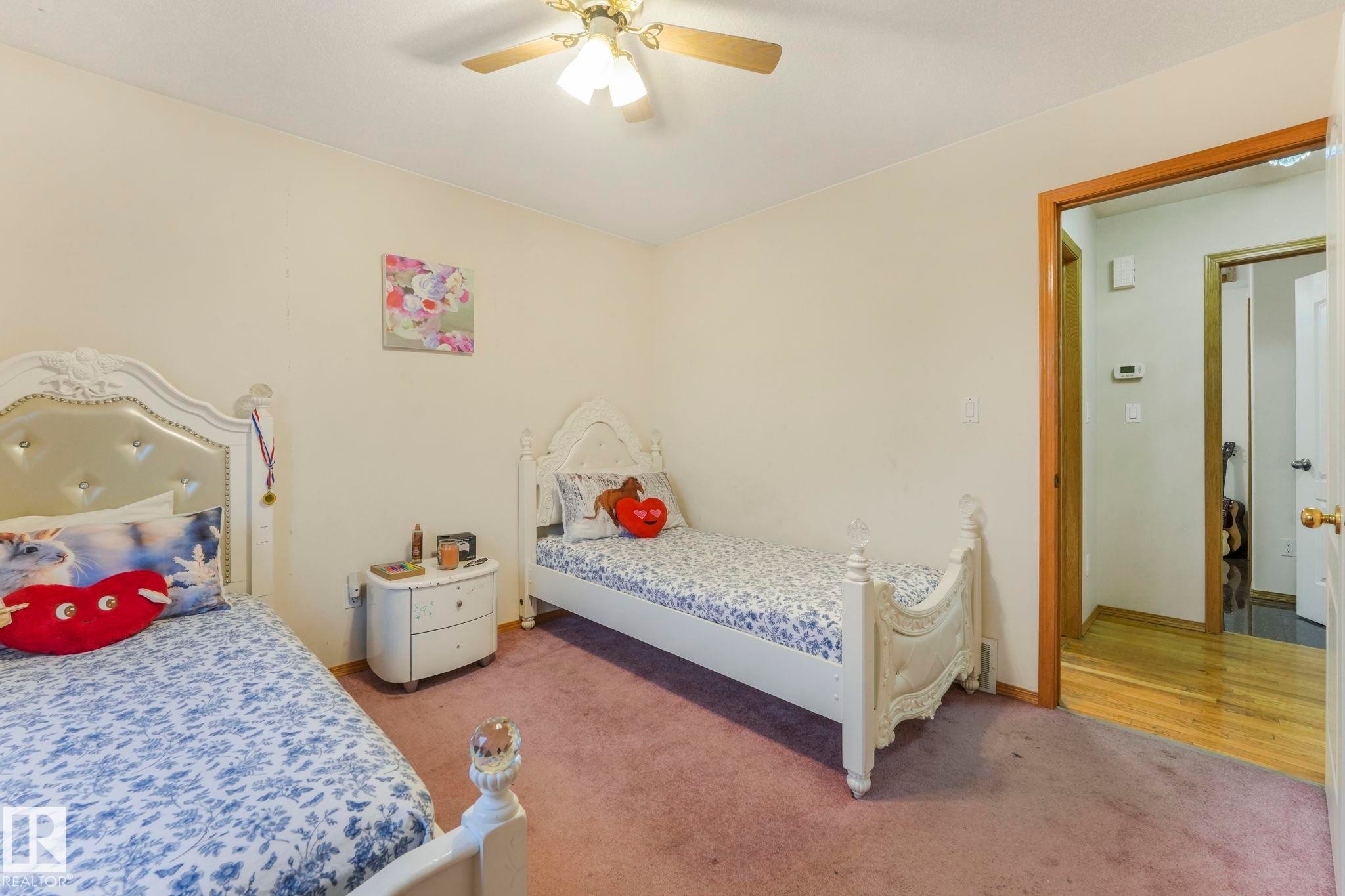 Carpeted bedroom with ceiling fan - 4720 150 Avenue, Edmonton, AB - Indoor Photo Showing Bedroom