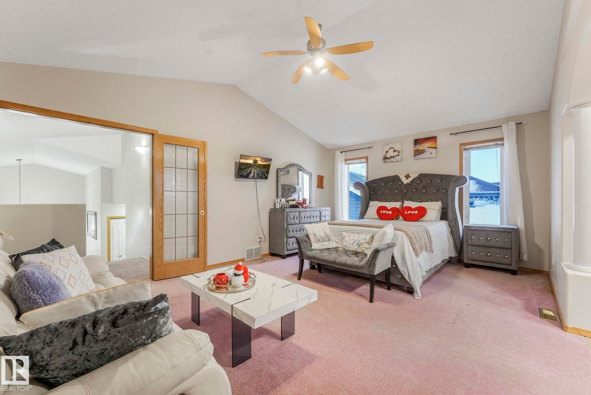 Carpeted bedroom with lofted ceiling and ceiling fan - 4720 150 Avenue, Edmonton, AB - Indoor Photo Showing Bedroom