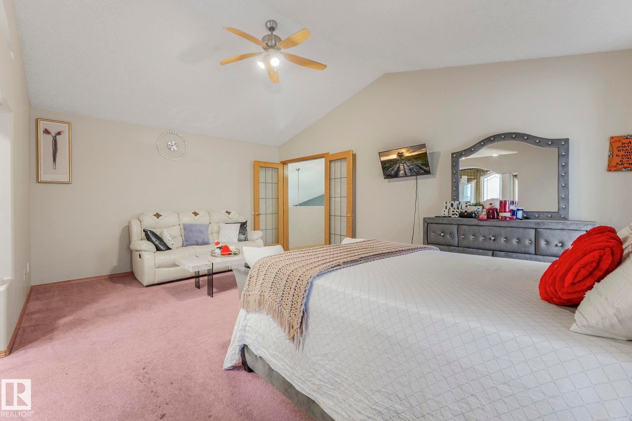 Bedroom featuring carpet floors, vaulted ceiling, and a ceiling fan - 4720 150 Avenue, Edmonton, AB - Indoor Photo Showing Bedroom