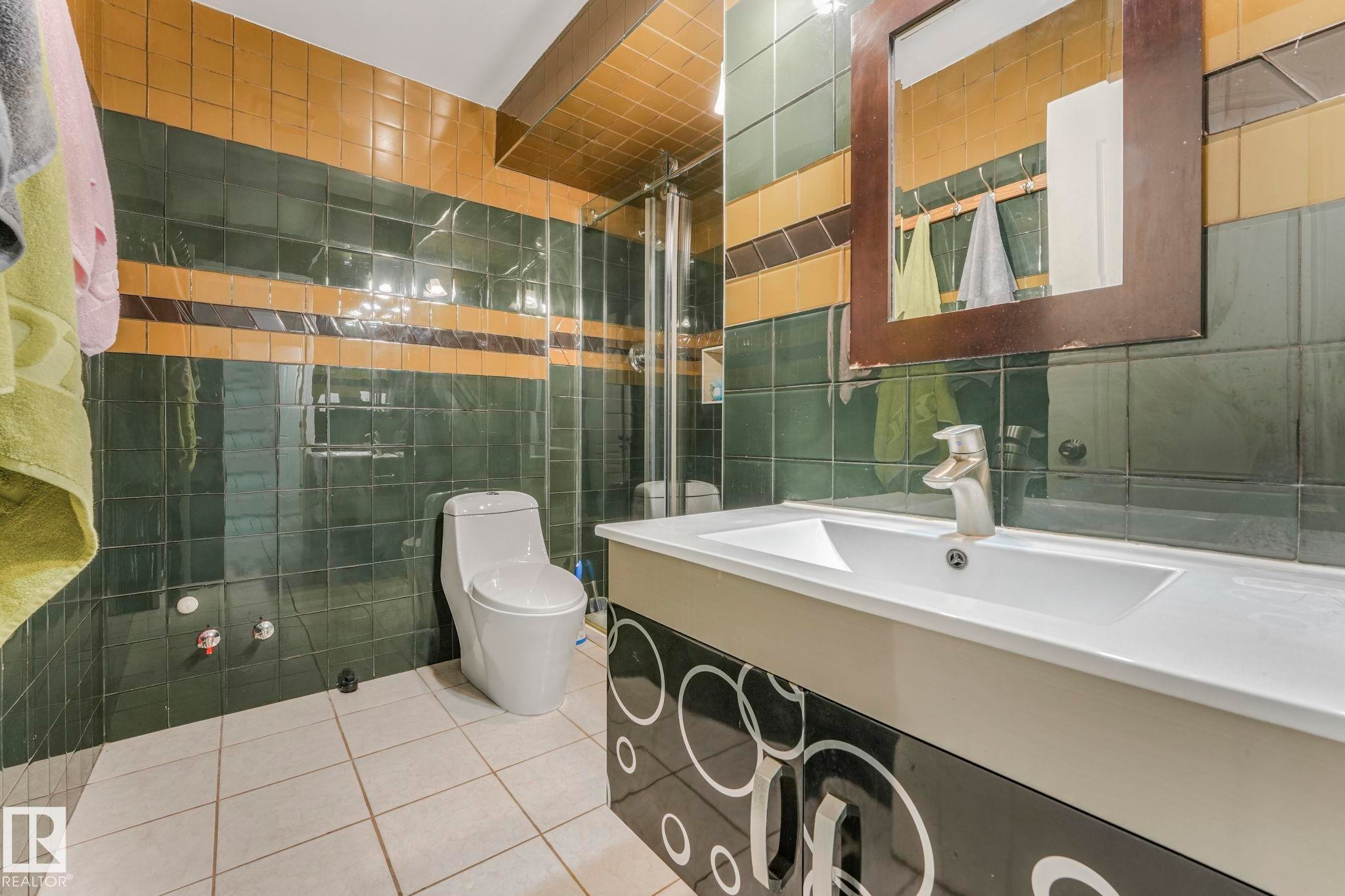 Full bath featuring tile walls, light tile patterned flooring, and vanity - 4720 150 Avenue, Edmonton, AB - Indoor Photo Showing Bathroom