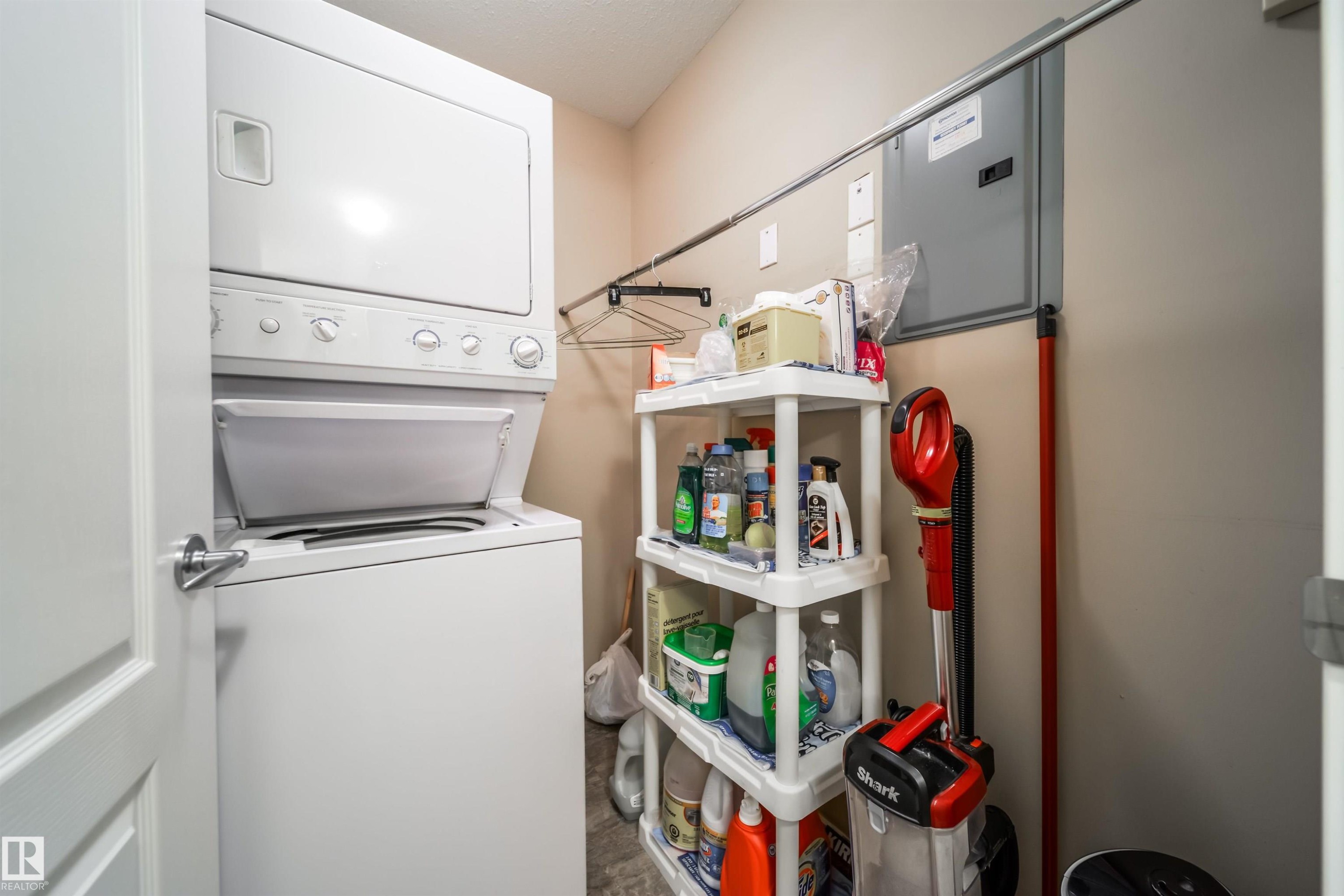 Laundry area with stacked washer and clothes dryer - 237 278 Suder Greens Drive, Edmonton, AB - Outdoor With Exterior