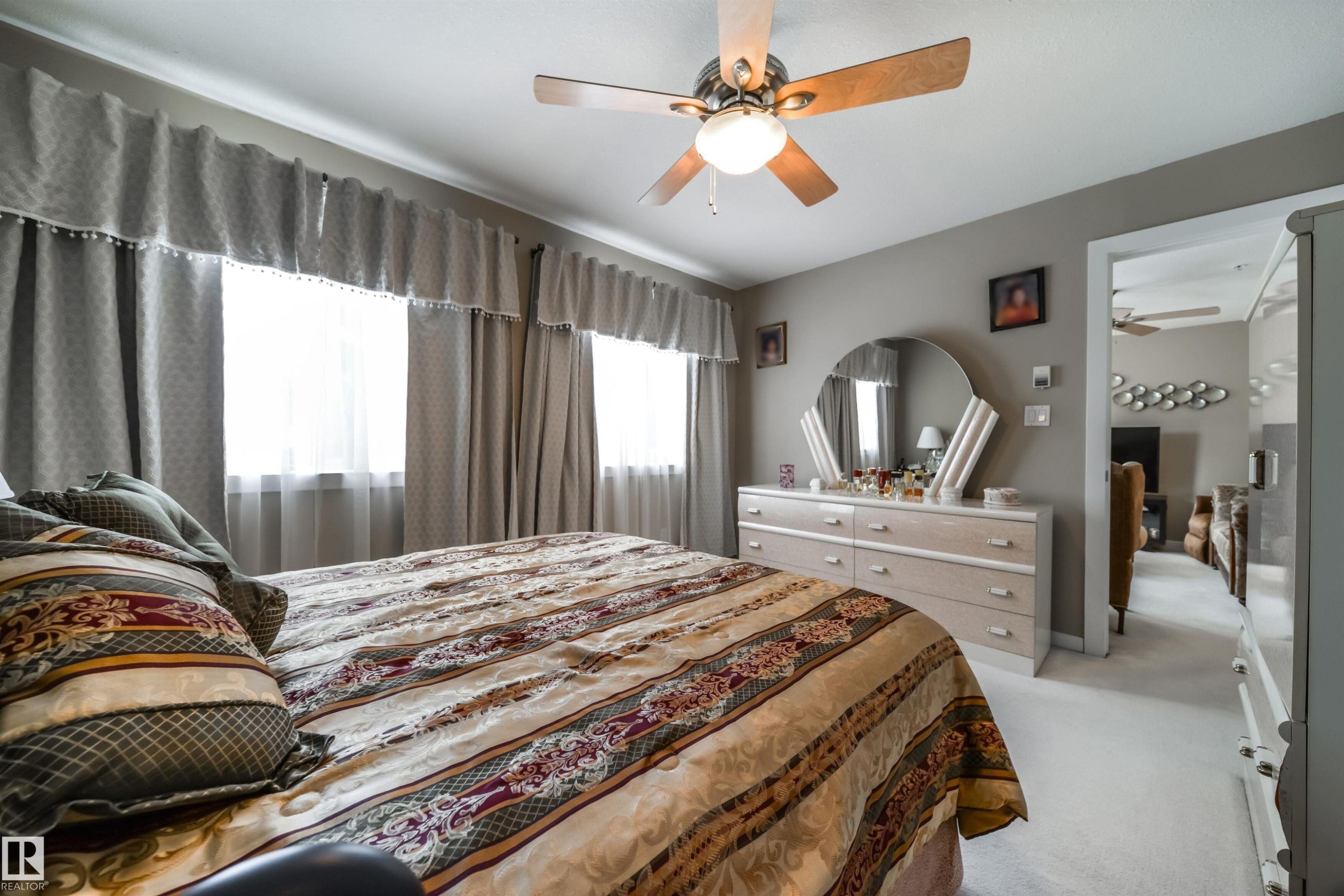 Bedroom featuring light colored carpet and ceiling fan - 237 278 Suder Greens Drive, Edmonton, AB - Indoor Photo Showing Living Room