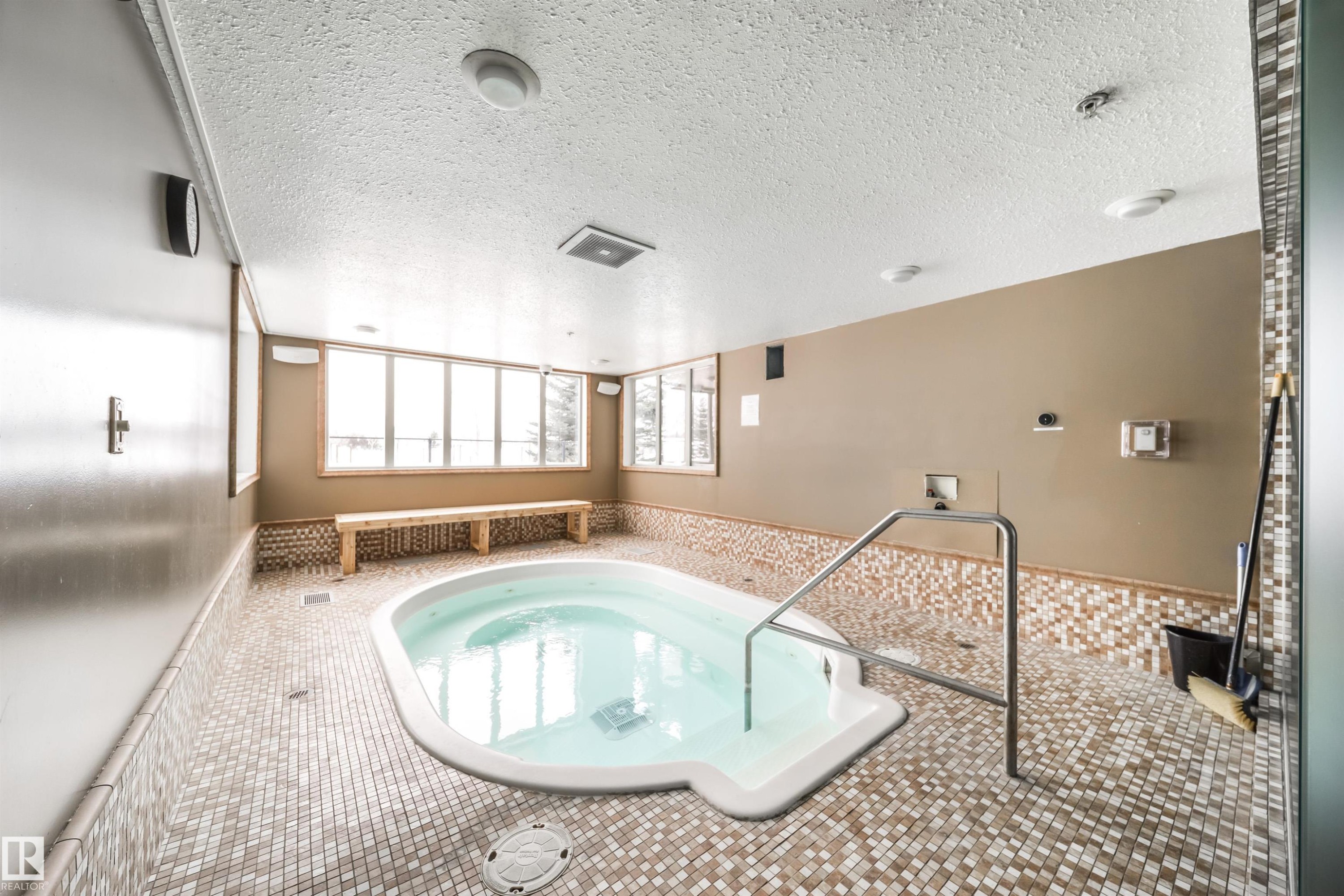 View of pool featuring a hot tub and a sunroom - 237 278 Suder Greens Drive, Edmonton, AB - Indoor