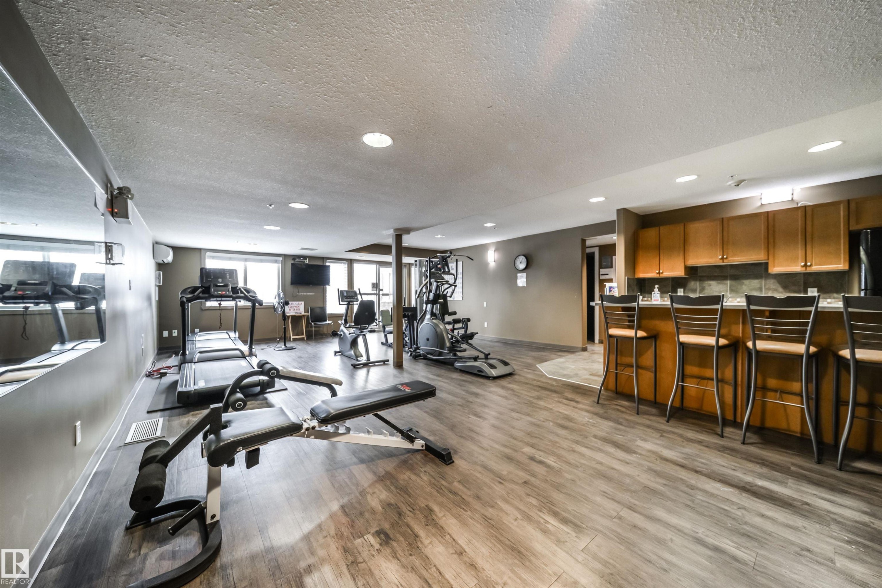 Exercise area featuring a textured ceiling and recessed lighting - 237 278 Suder Greens Drive, Edmonton, AB - Indoor Photo Showing Other Room