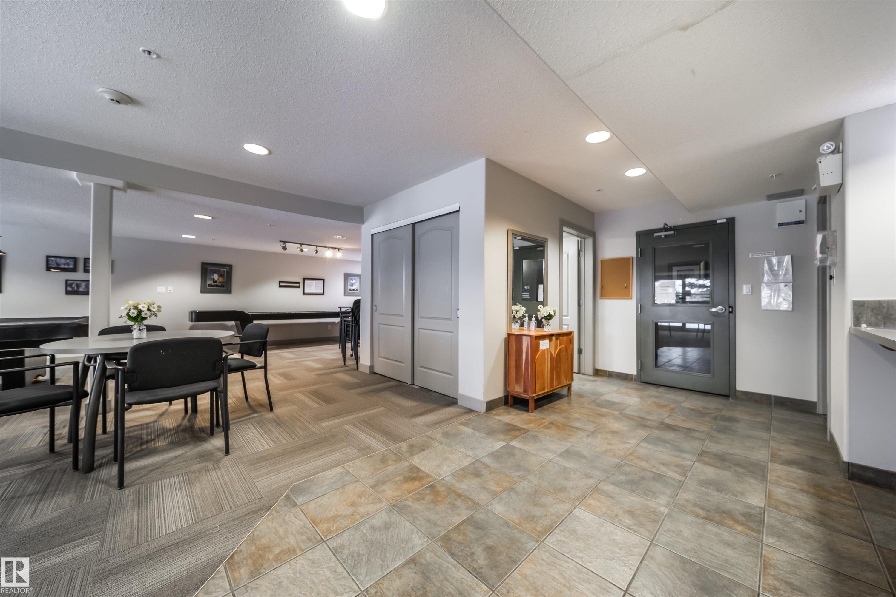 Kitchen featuring recessed lighting, a textured ceiling, open floor plan, and light countertops - 237 278 Suder Greens Drive, Edmonton, AB - Other