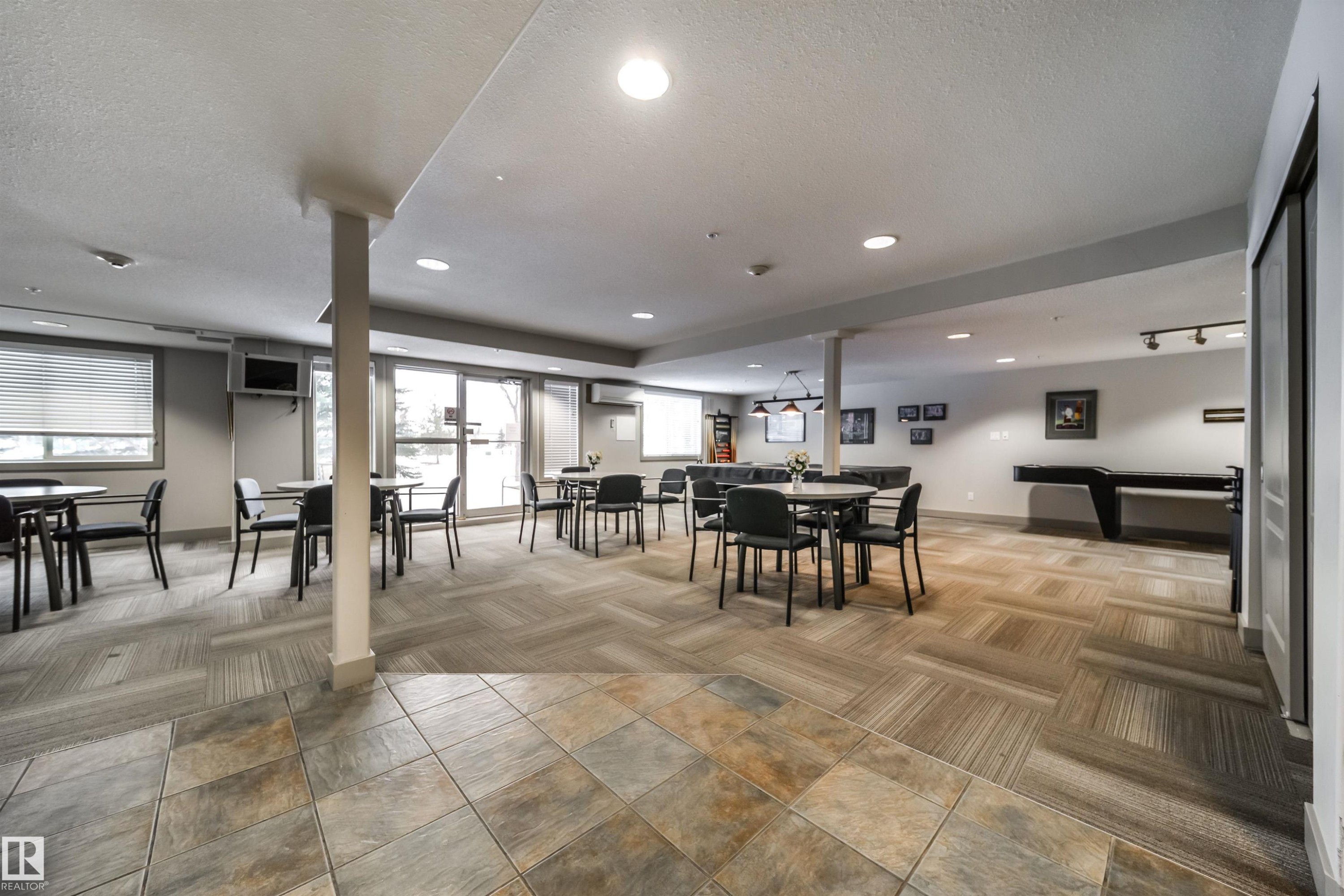 Dining space featuring light colored carpet, a textured ceiling, and recessed lighting - 237 278 Suder Greens Drive, Edmonton, AB - Outdoor