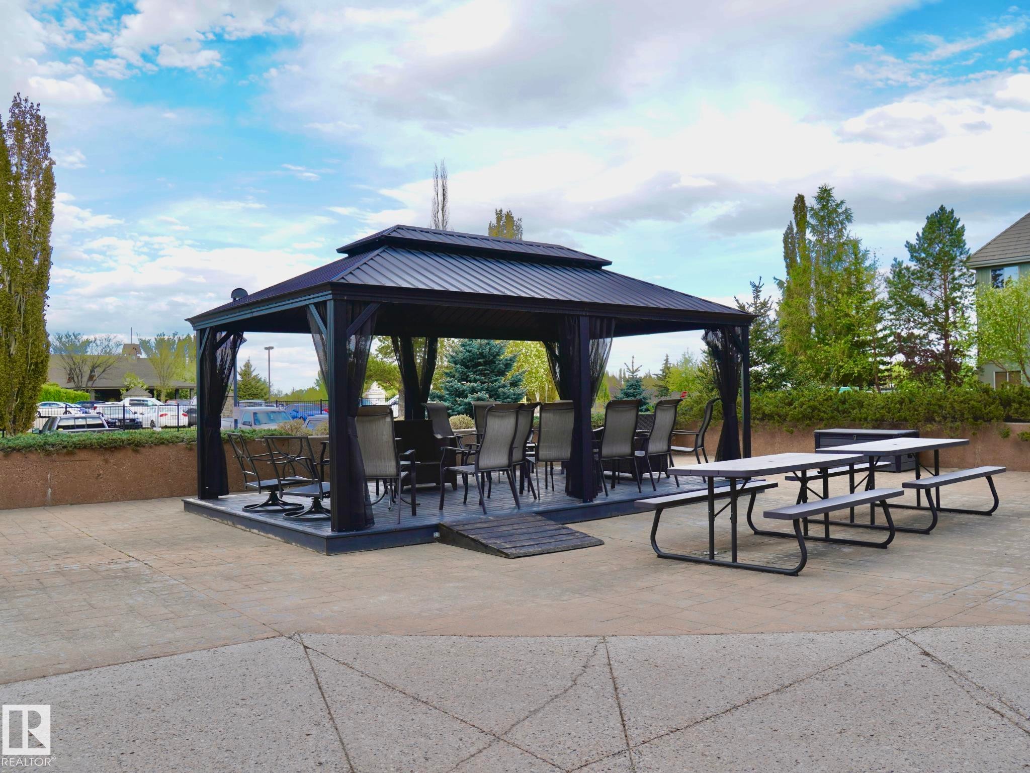 Outdoor gazebo with a black metal frame and dark mesh privacy screens - 237 278 Suder Greens Drive, Edmonton, AB - Outdoor