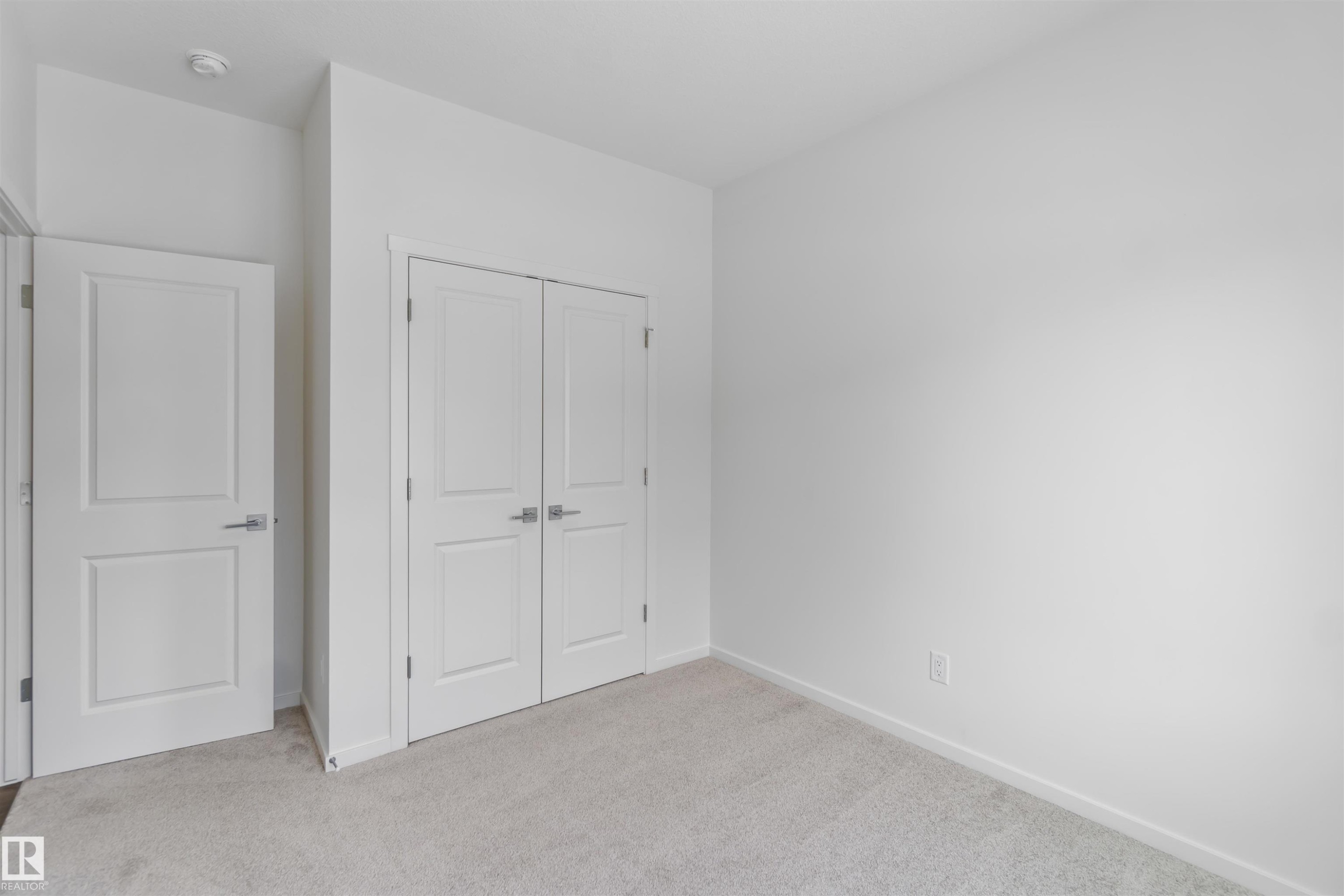 Unfurnished bedroom featuring light carpet and a closet - 2467 Alces Link Link, Edmonton, AB - Indoor Photo Showing Other Room