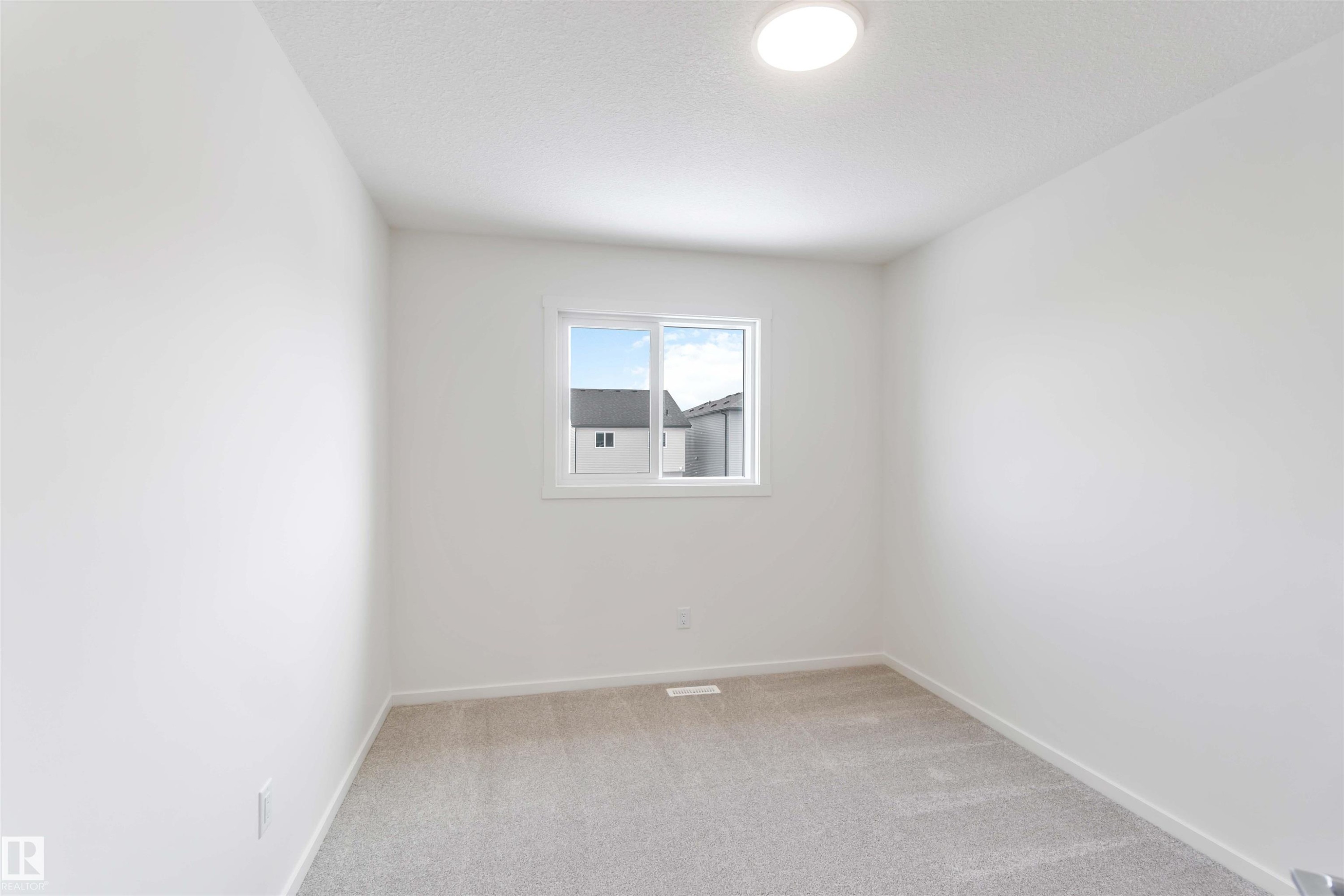 Spare room featuring light carpet and baseboards - 2467 Alces Link Link, Edmonton, AB - Indoor Photo Showing Other Room