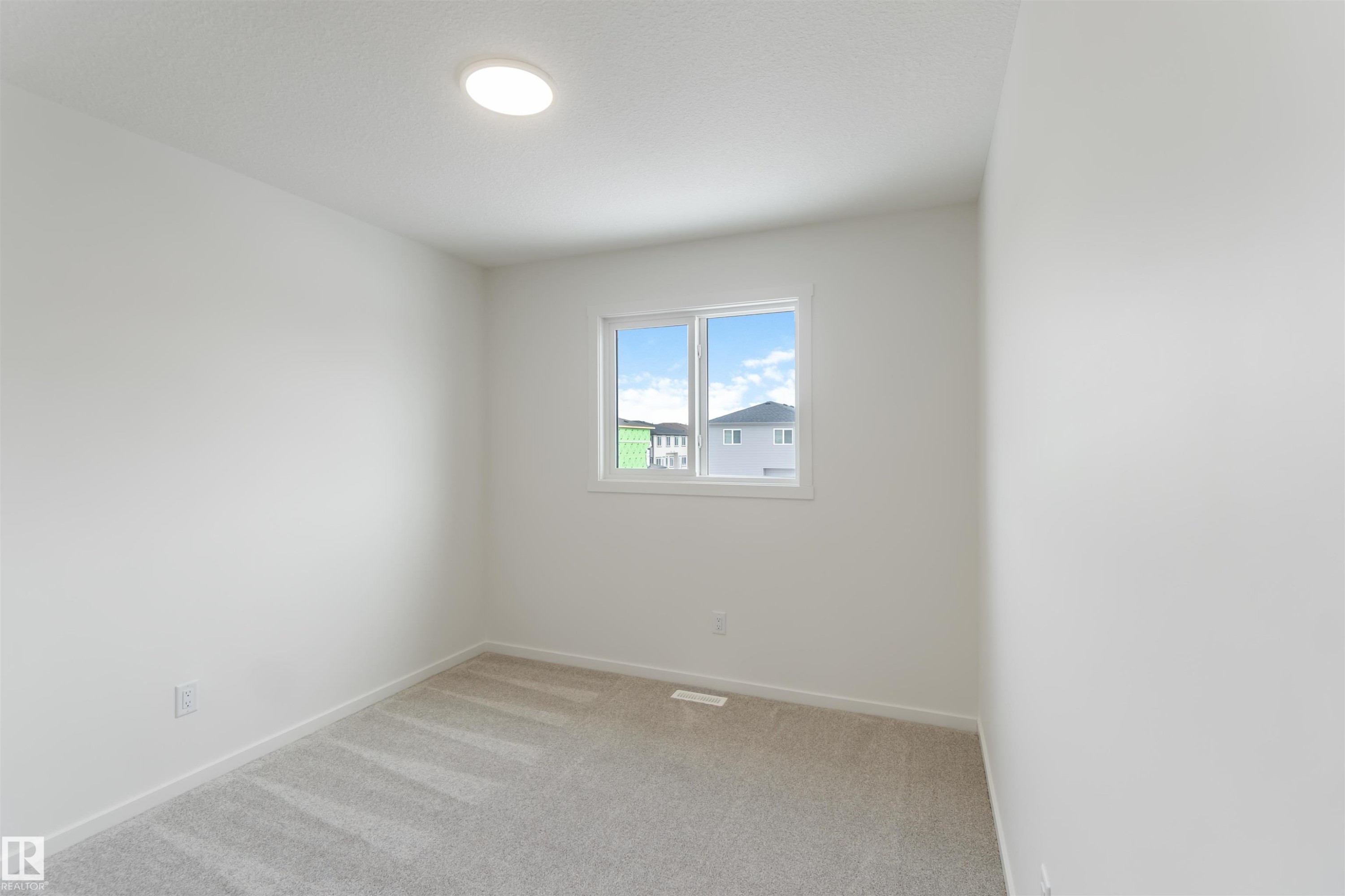 Unfurnished room with light carpet and baseboards - 2467 Alces Link Link, Edmonton, AB - Indoor Photo Showing Other Room