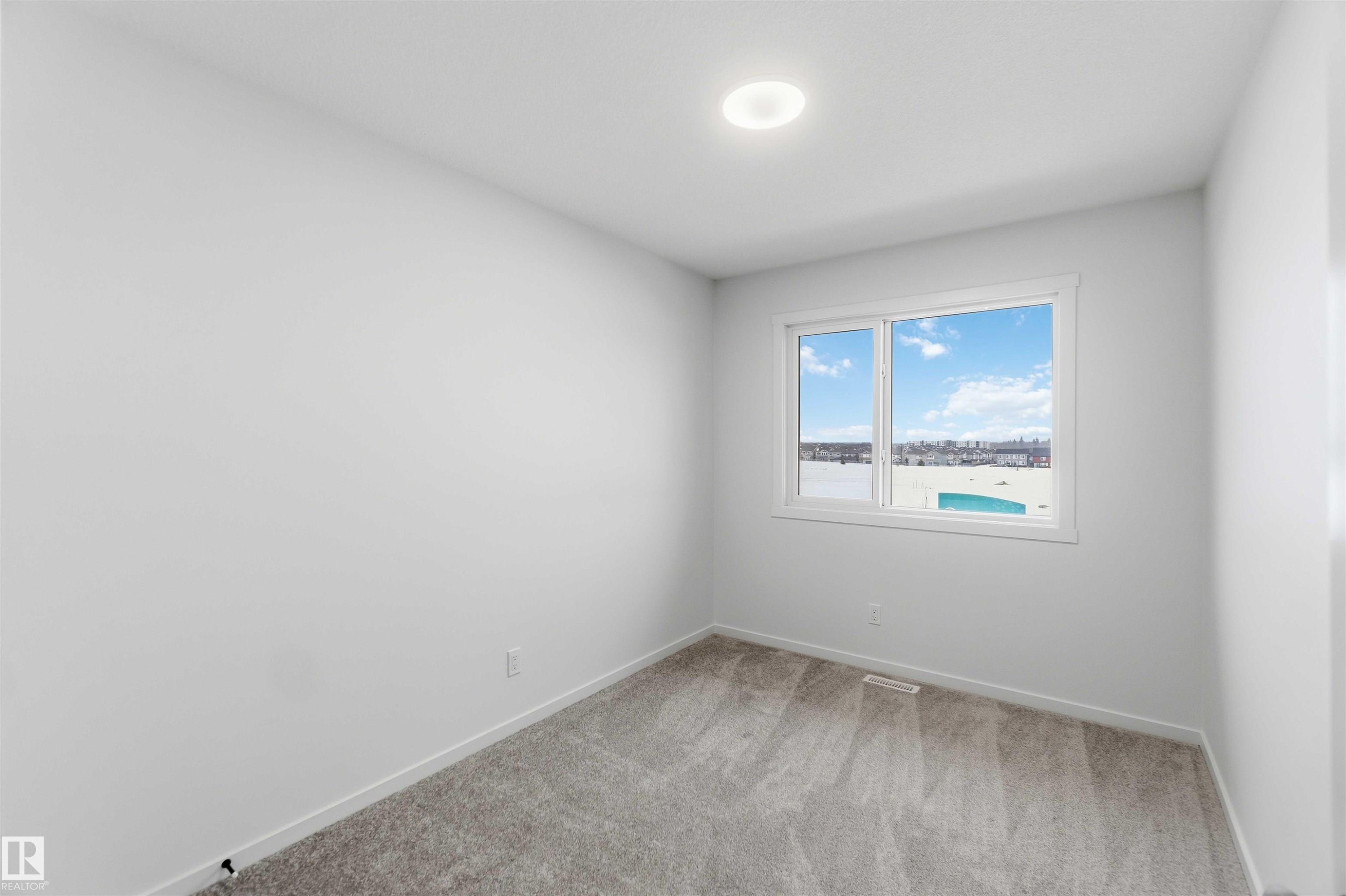 Empty room featuring baseboards and light carpet - 8652 Edgemont Link, Edmonton, AB - Indoor Photo Showing Other Room