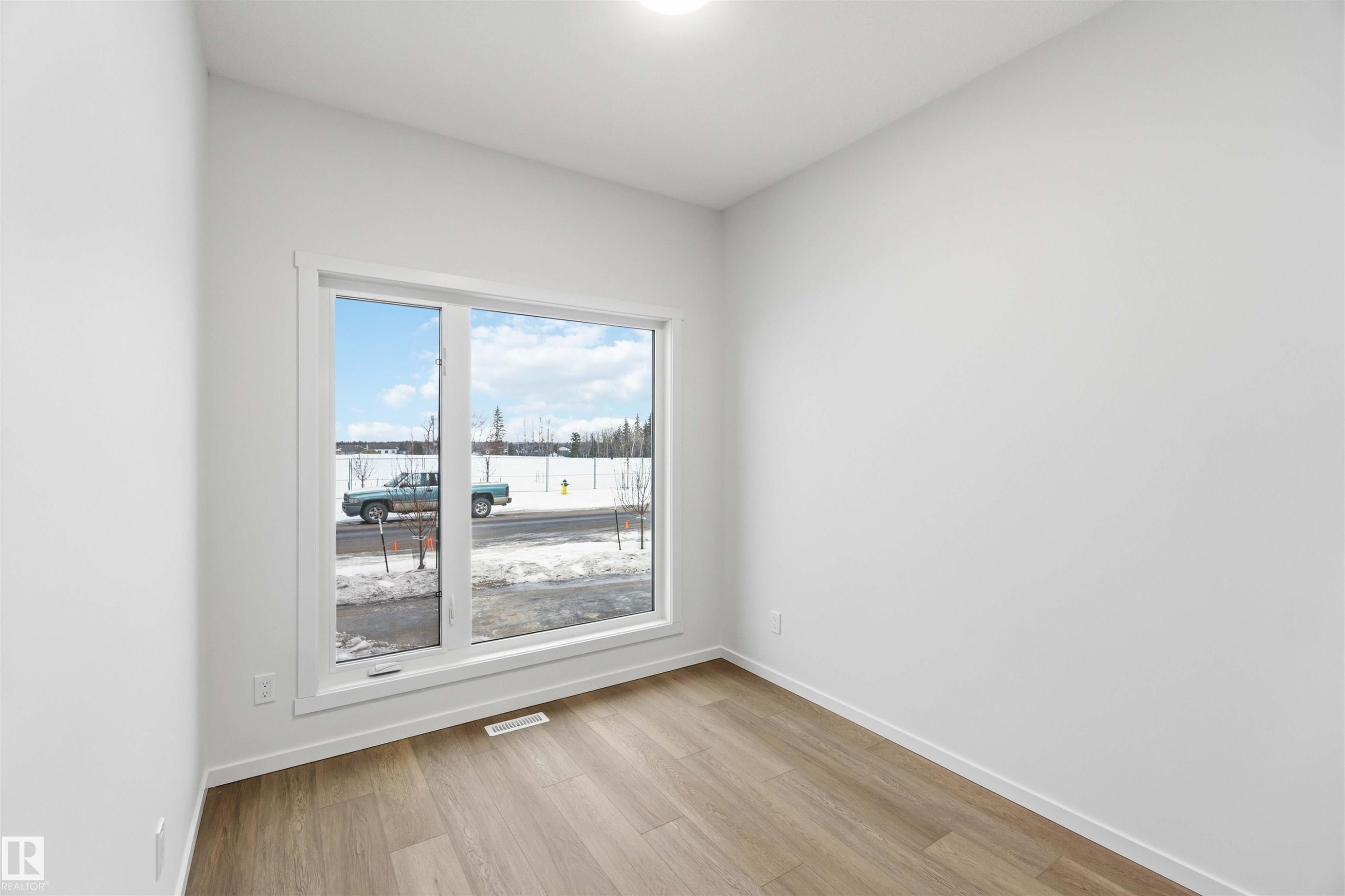 Unfurnished room featuring light wood-type flooring and baseboards - 8652 Edgemont Link, Edmonton, AB - Indoor Photo Showing Other Room