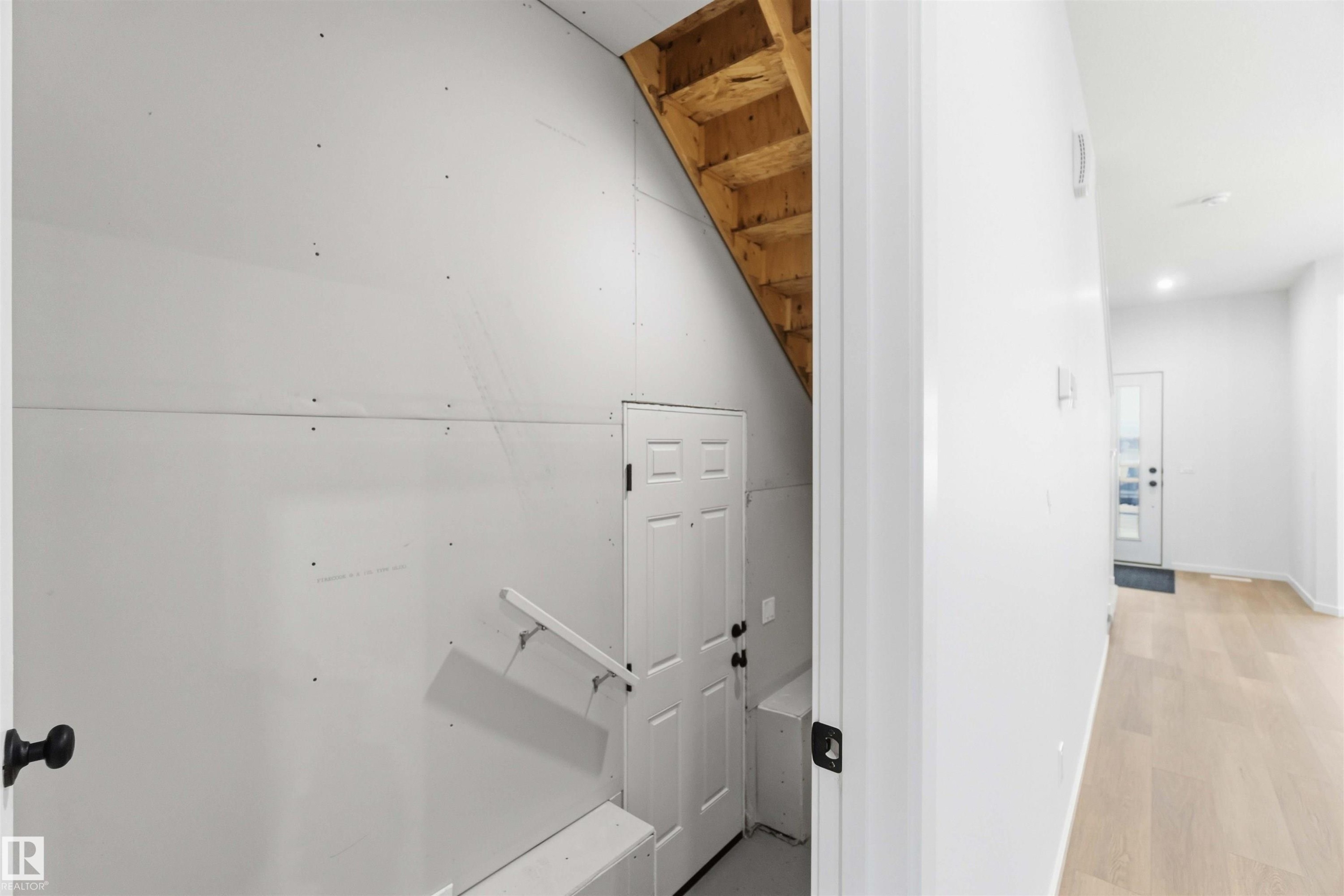Stairs featuring wood finished floors - 8652 Edgemont Link, Edmonton, AB - Indoor Photo Showing Other Room