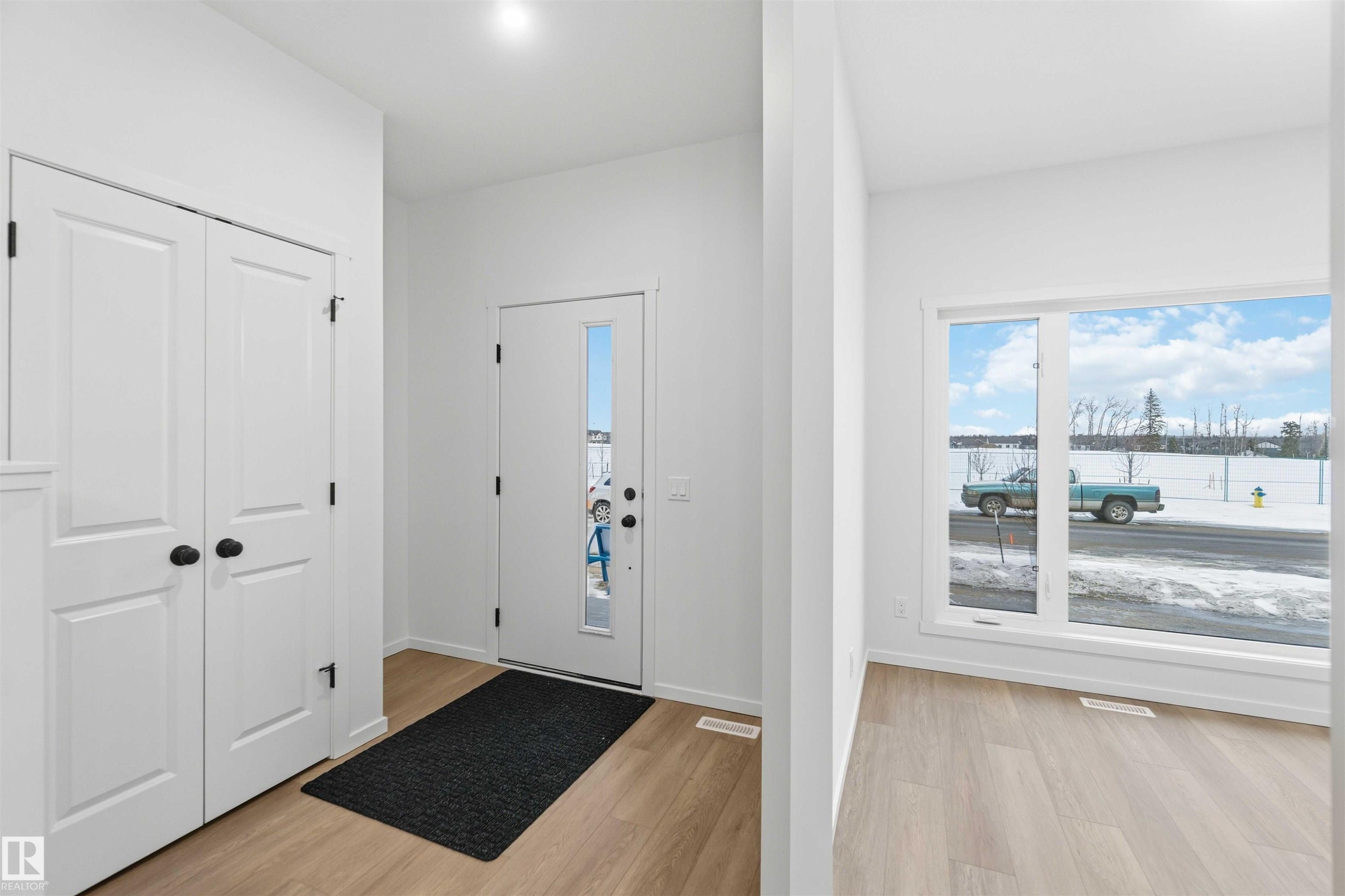 Foyer with light wood-style flooring and baseboards - 8652 Edgemont Link, Edmonton, AB - Indoor Photo Showing Other Room