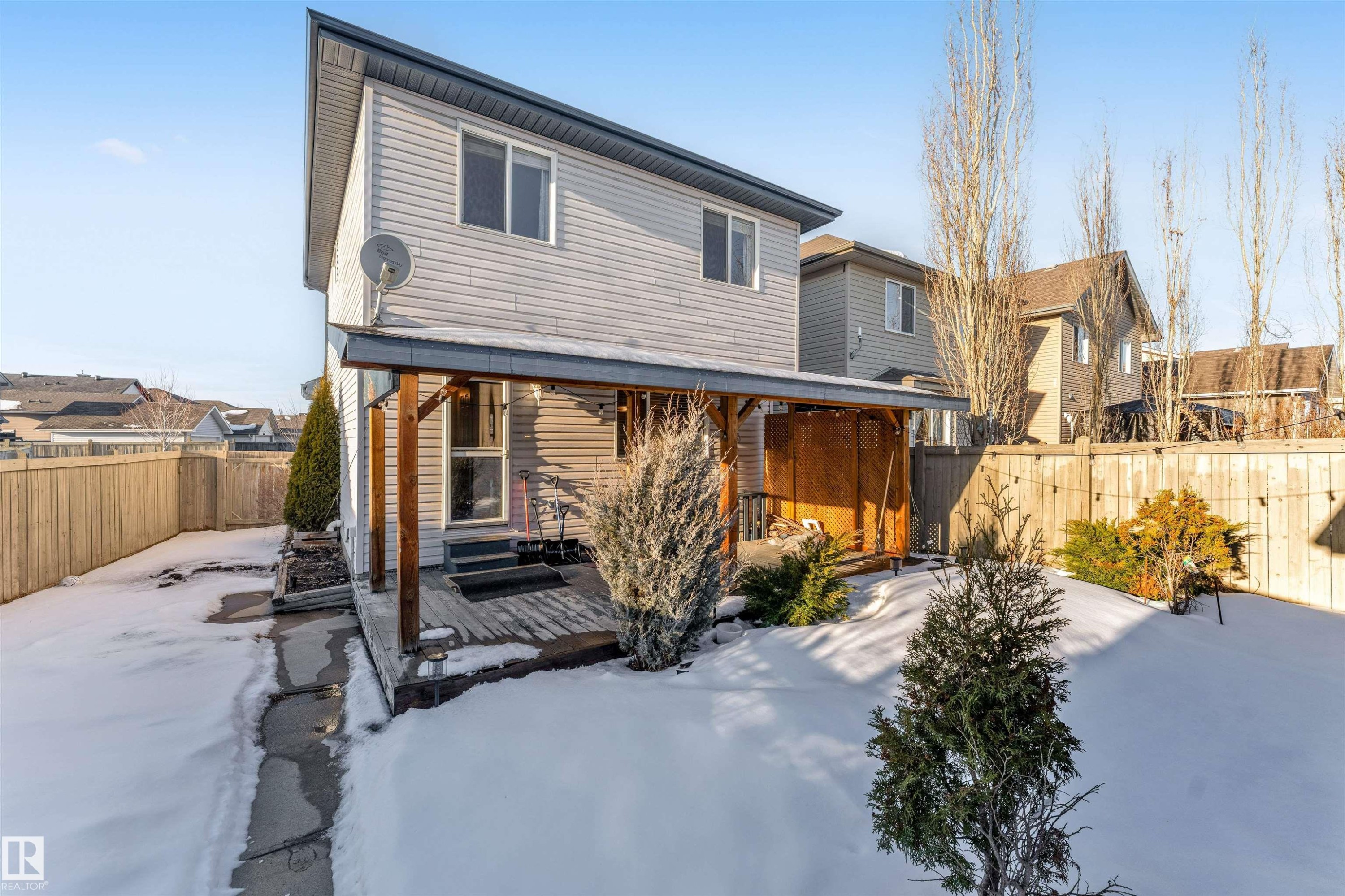 Snow covered back of property featuring a deck and a fenced backyard - 1157 37 Avenue, Edmonton, AB - Outdoor With Deck Patio Veranda