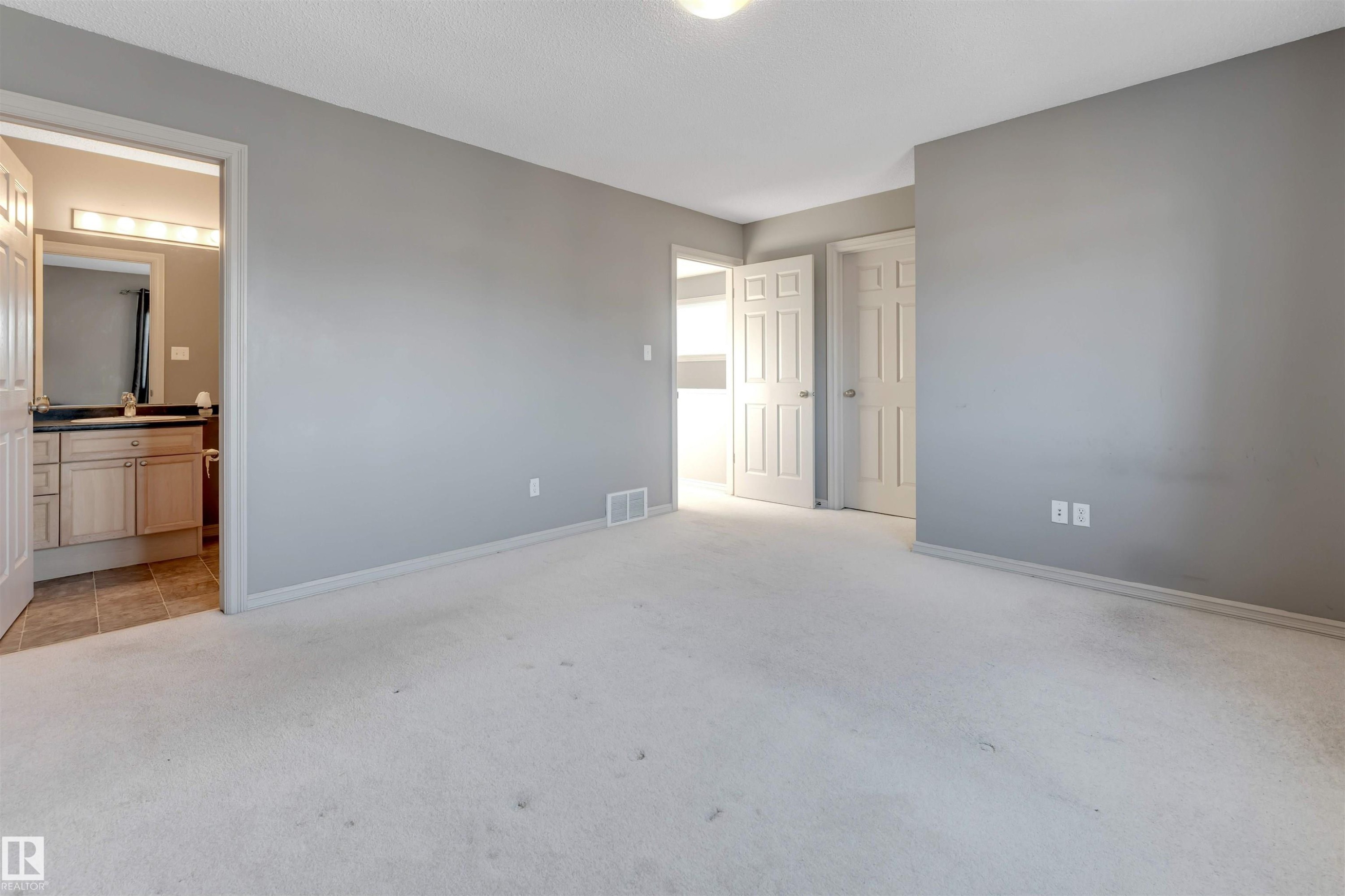 Unfurnished bedroom with light carpet and connected bathroom - 1157 37 Avenue, Edmonton, AB - Indoor Photo Showing Other Room