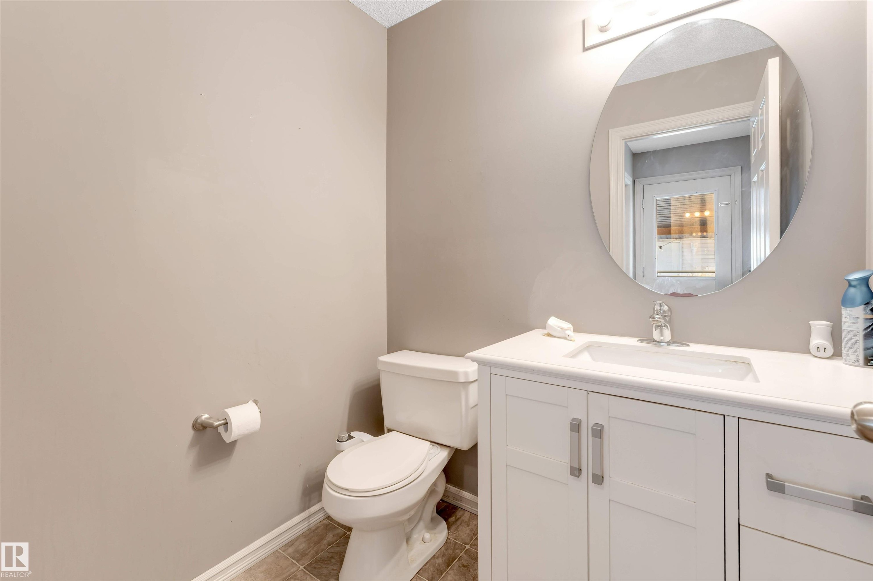 Half bath with vanity and light tile patterned floors - 1157 37 Avenue, Edmonton, AB - Indoor Photo Showing Bathroom