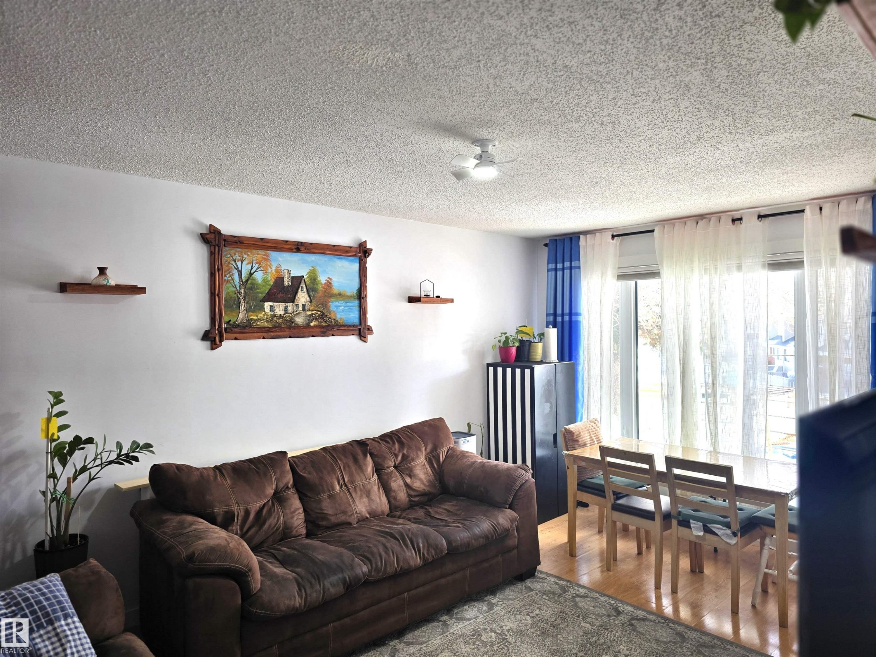 This living area features light-colored walls and a textured ceiling - 80 Amberly Crest, Edmonton, AB - Indoor Photo Showing Living Room