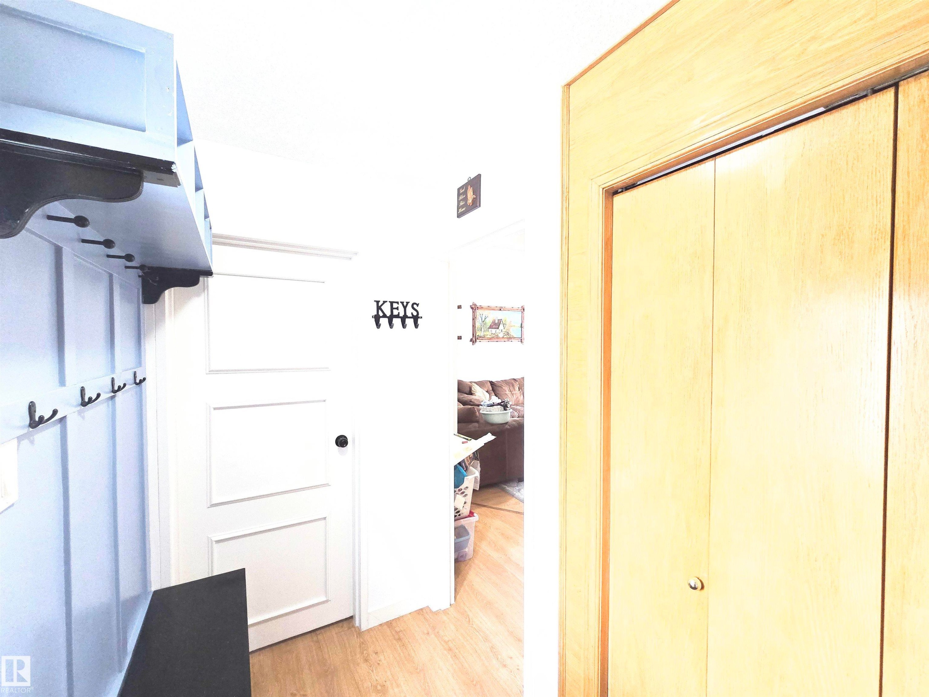 Corridor with light wood-style flooring - 80 Amberly Crest, Edmonton, AB -