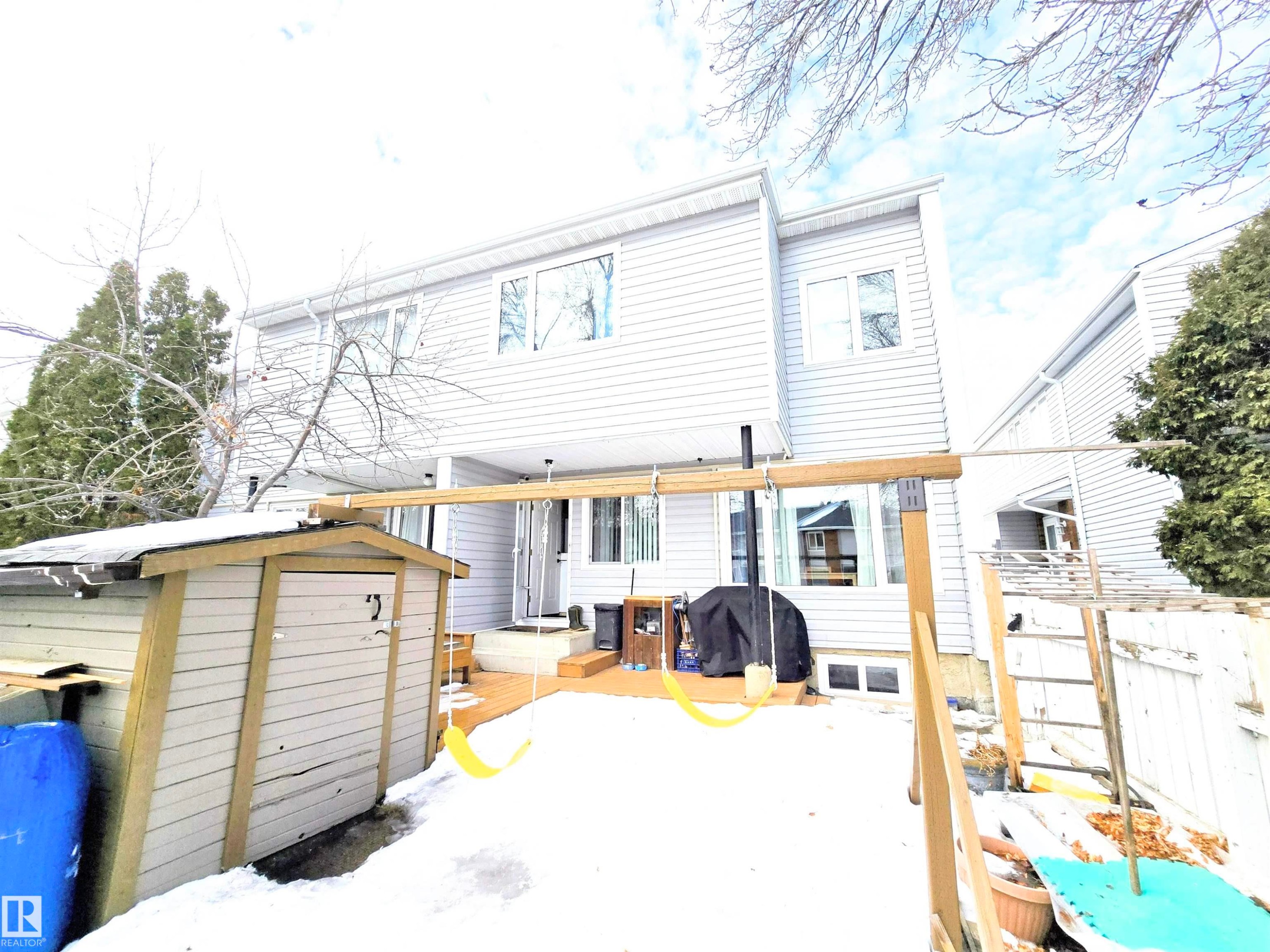 Rear view of property with a storage shed and a wooden deck - 80 Amberly Crest, Edmonton, AB - Outdoor