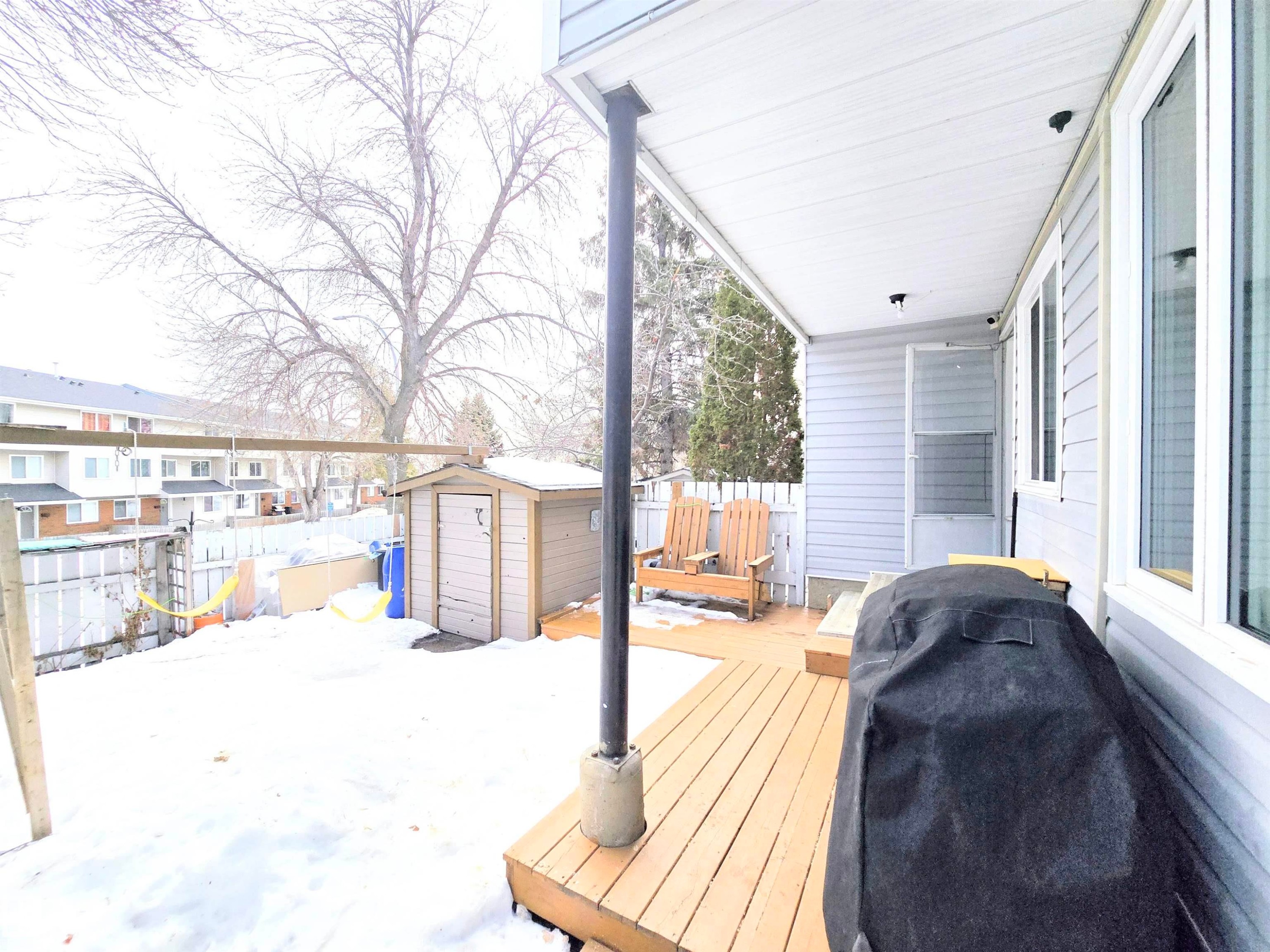 Wooden terrace with a storage shed and area for grilling - 80 Amberly Crest, Edmonton, AB - Outdoor With Exterior